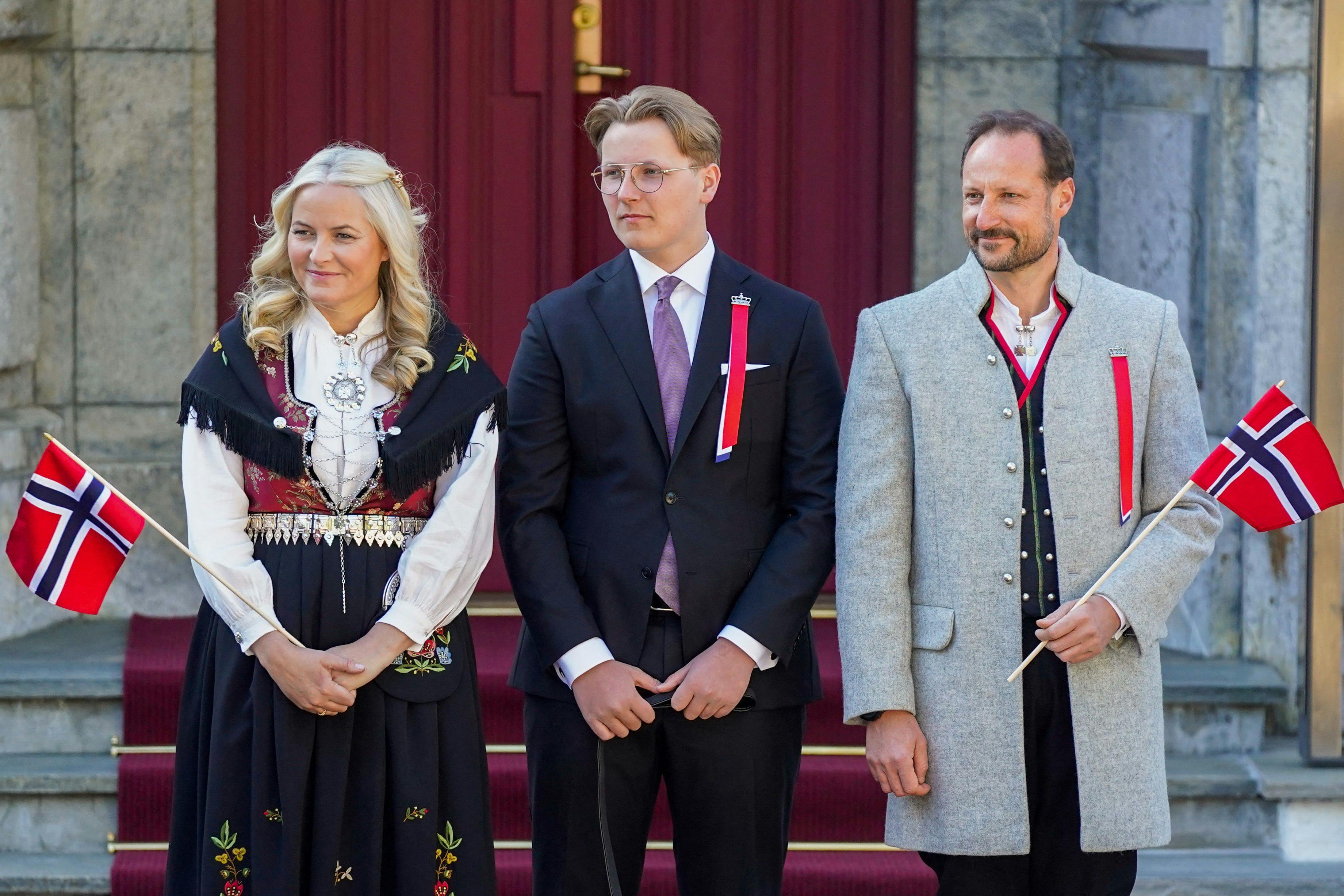 (L-R) Norway's Crown Princess Mette-Marit, Prince Sverre Magnus and Crown Prince Haakon greet and watch the children's parade during the May 17th celebrations at the royal residence Skaugum, in Asker, near Oslo.. (Photo by Lise Åserud / NTB / AFP) / Norway OUT