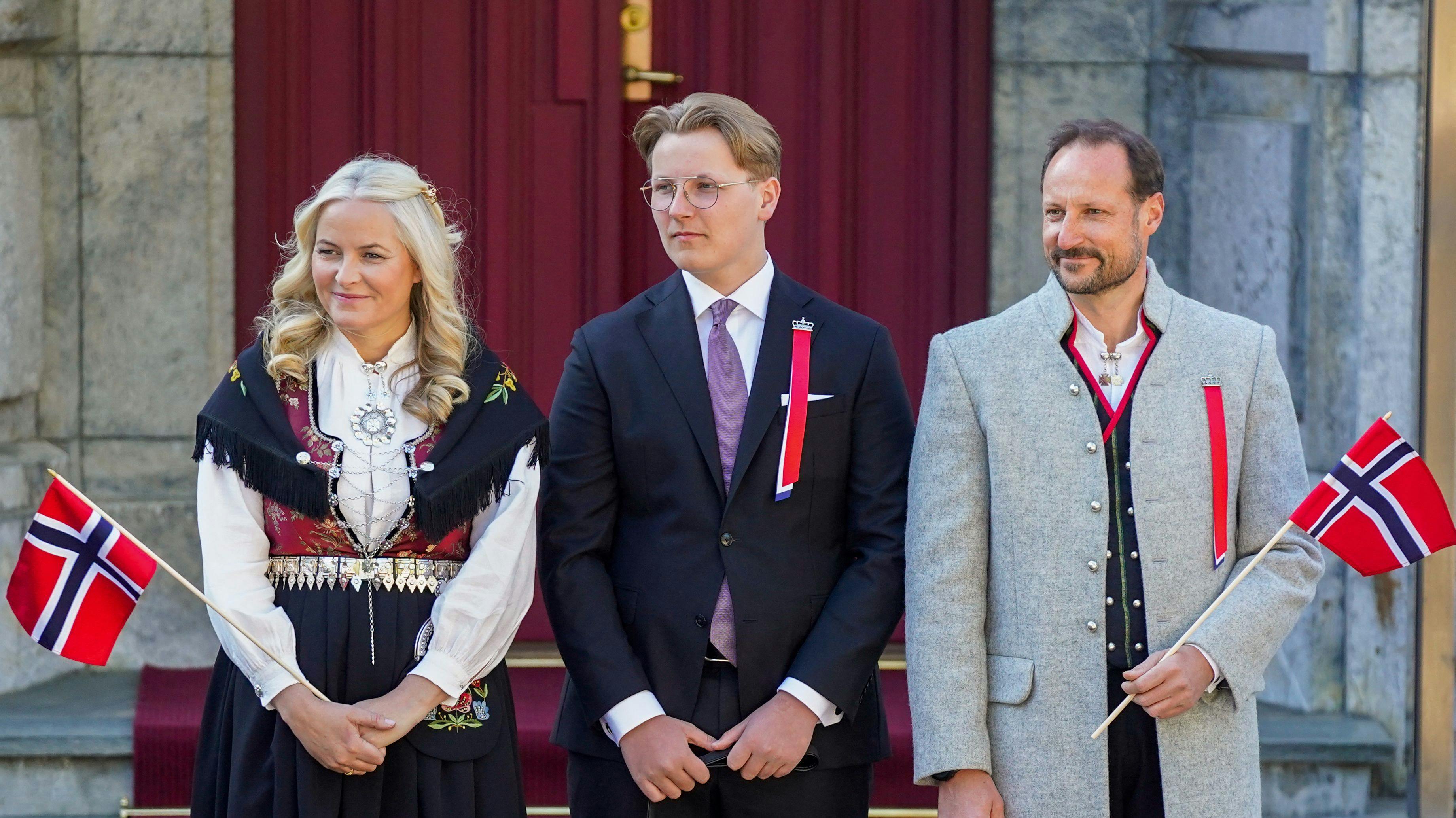 (L-R) Norway's Crown Princess Mette-Marit, Prince Sverre Magnus and Crown Prince Haakon greet and watch the children's parade during the May 17th celebrations at the royal residence Skaugum, in Asker, near Oslo.. (Photo by Lise Åserud / NTB / AFP) / Norway OUT