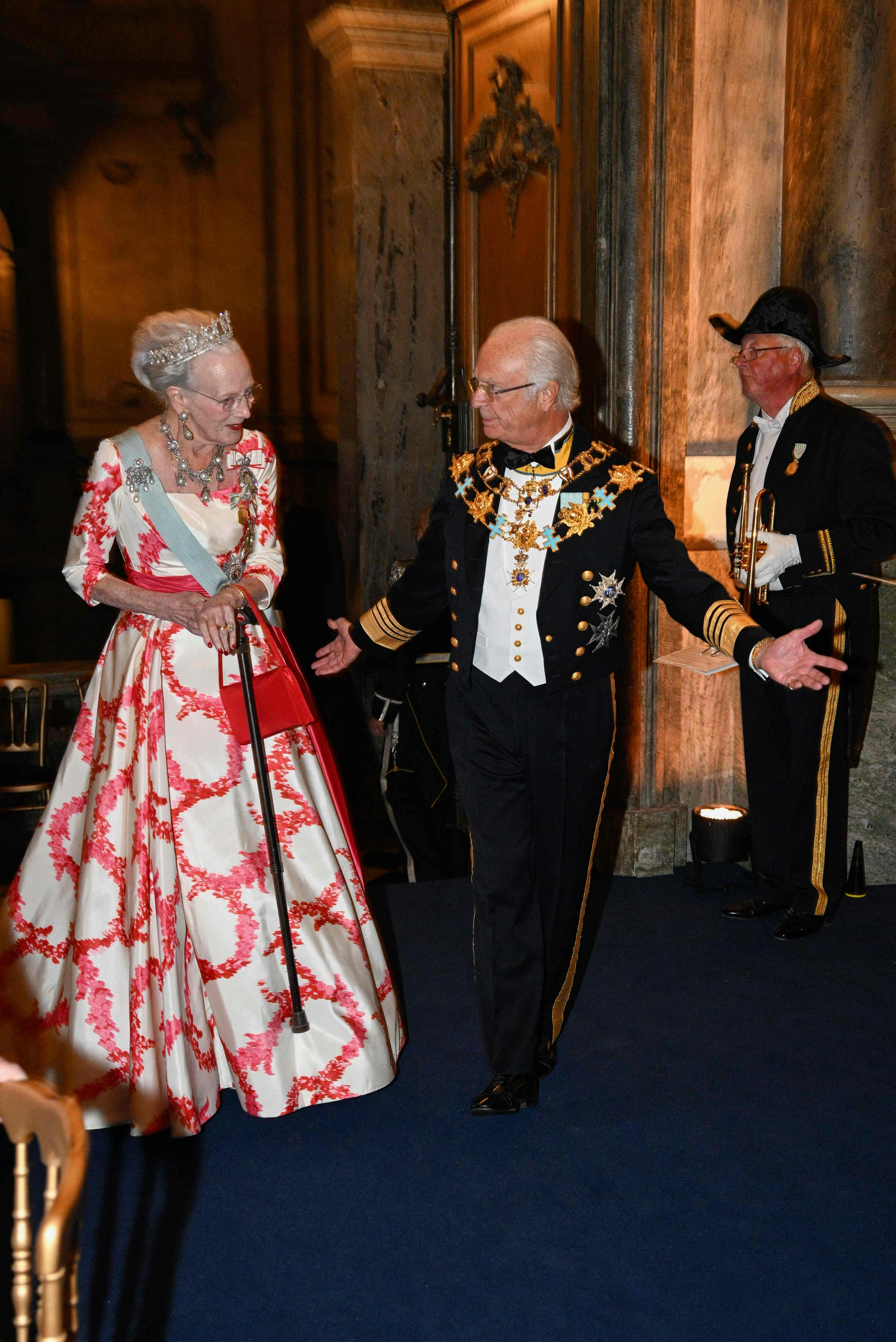 King Carl XVI Gustaf of Sweden and Denmark's Queen Margrethe arrive at the jubilee banquet in the Rikssalen at Stockholm Palace on the occasion of the 50th anniversary of King Carl XVI Gustaf's accession to the throne at the Royal Palace in Stockholm, Sweden, on September 15, 2023. (Photo by Anders WIKLUND / various sources / AFP) / Sweden OUT