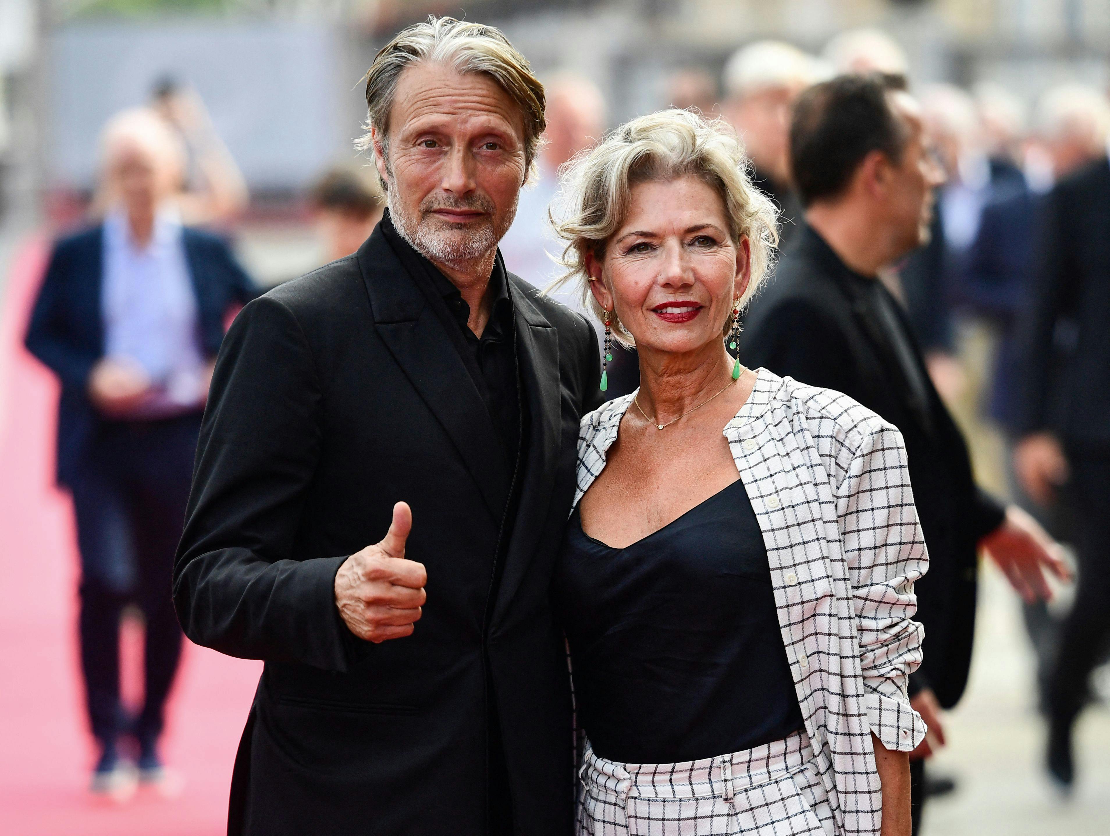Danish actor Mads Mikkelsen (L) and Danish producer Tine Mikkelsen pose on the red carpet ahead of the screening of the film "Bastarden / The promised land" during the 71st edition of the San Sebastian Film Festival in the northern Spanish Basque city of San Sebastian on September 26, 2023. (Photo by ANDER GILLENEA / AFP)