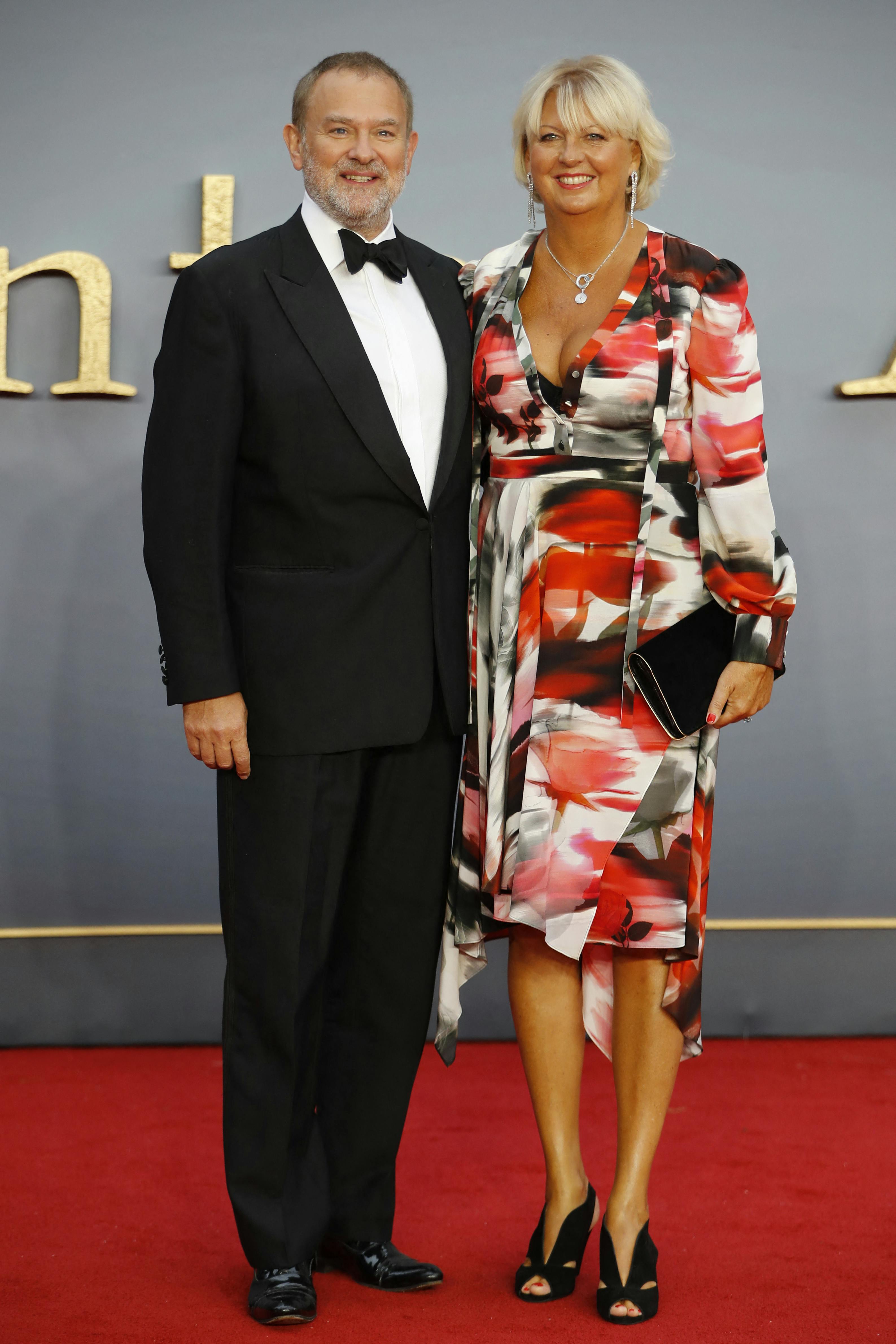 British actor Hugh Bonneville (L) and his wife Lulu Williams (R) pose on the red carpet upon arrival for the world premiere of the film "Downton Abbey" in London on Spetember 9, 2019.  Tolga AKMEN / AFP