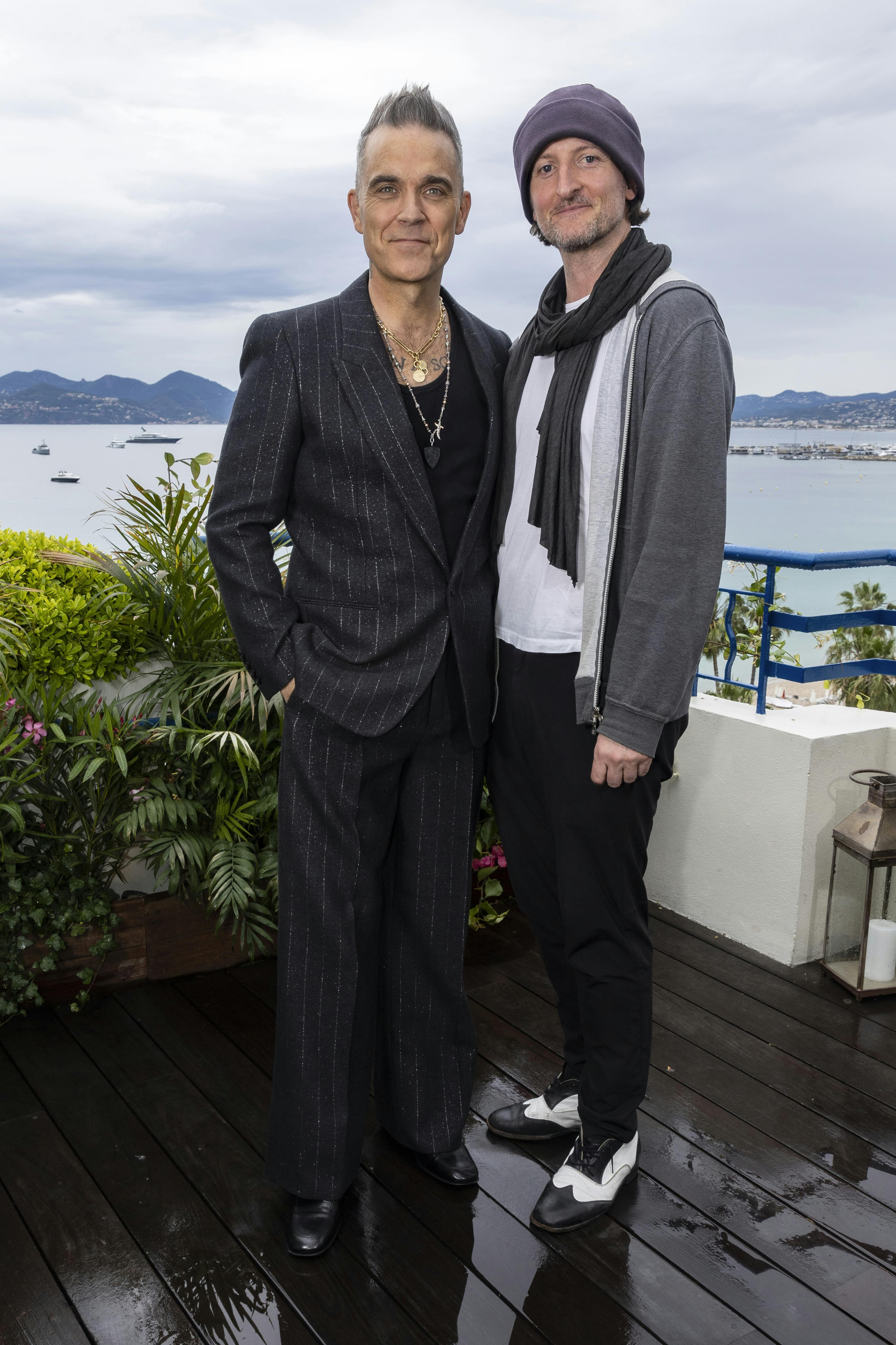 Robbie Williams, left, and director Michael Gracey pose for portrait photographs for the film 'Better Man', at the 76th international film festival, Cannes, southern France, Saturday, May 20, 2023. (Photo by Joel C Ryan/Invision/AP)