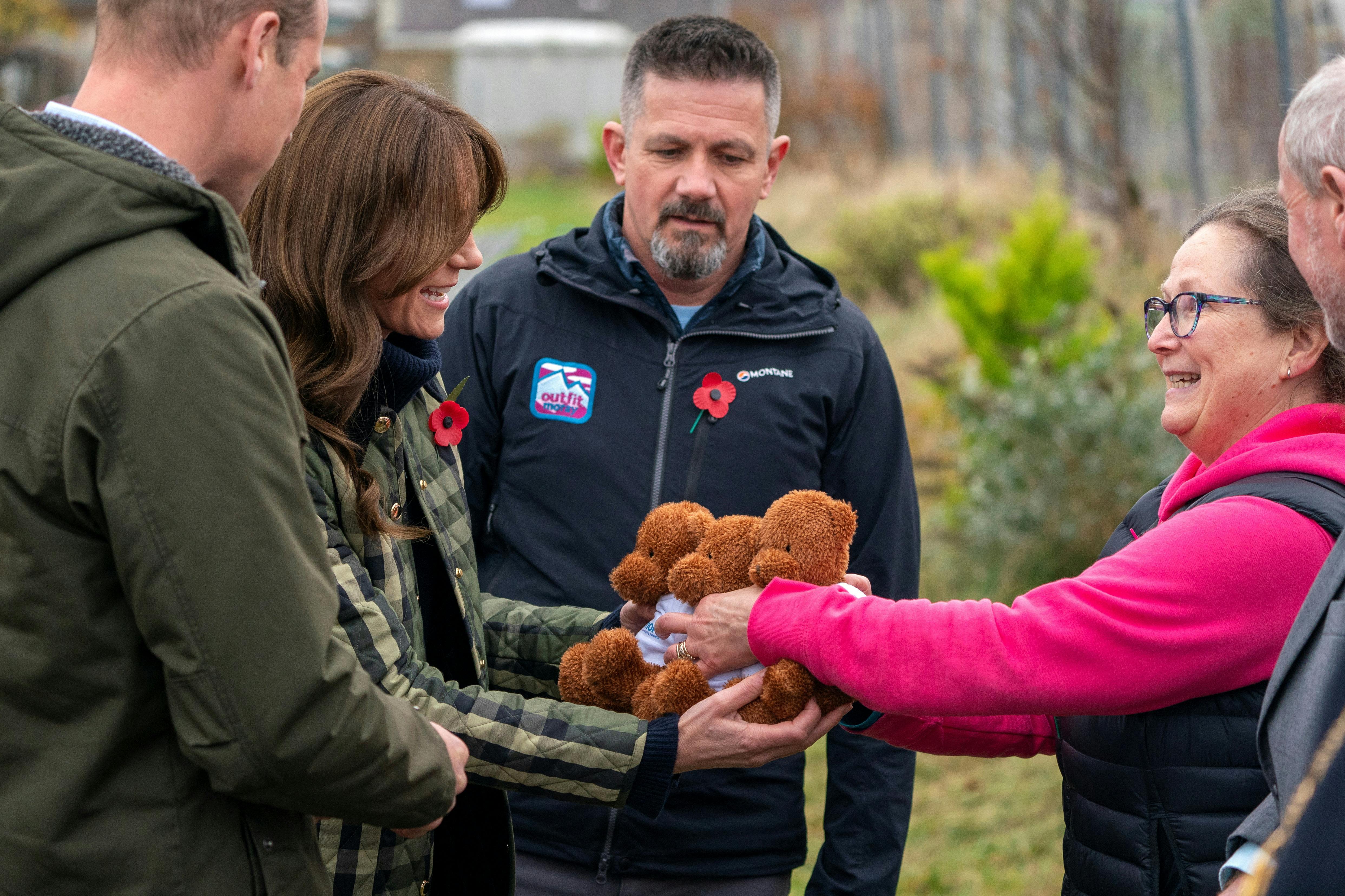 Britain's Prince William, and Kate, the Princess of Wales also known as the Duke and Duchess of Rothesay when in Scotland, are presented with 3 teddy bears for their children during their visit to Outfit Moray, in Moray, Scotland, Britain November 2, 2023. Jane Barlow/Pool via REUTERS