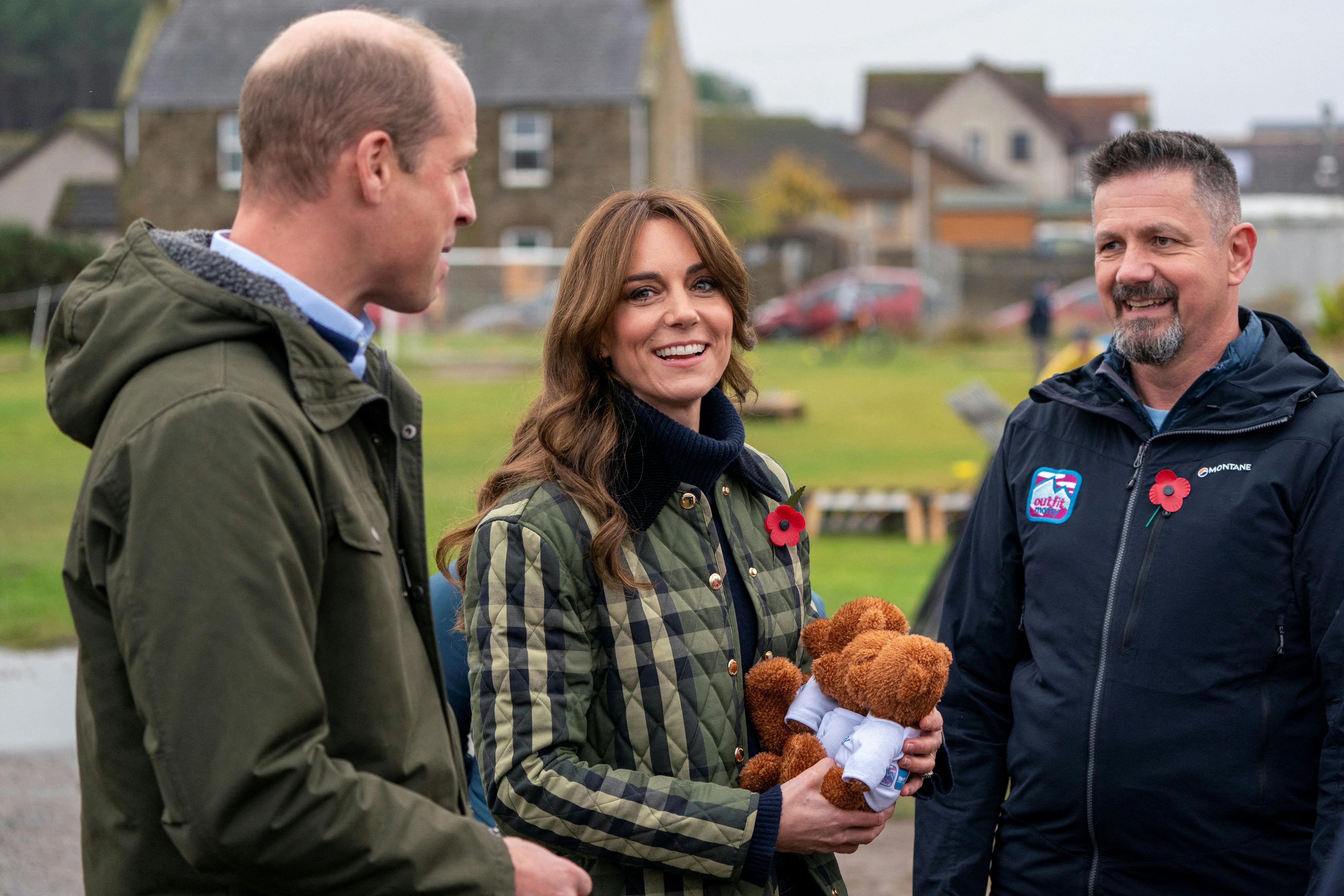 Britain's Prince William, and Kate, the Princess of Wales also known as the Duke and Duchess of Rothesay when in Scotland, are presented with 3 teddy bears for their children during their visit to Outfit Moray, in Moray, Scotland, Britain November 2, 2023. Jane Barlow/Pool via REUTERS