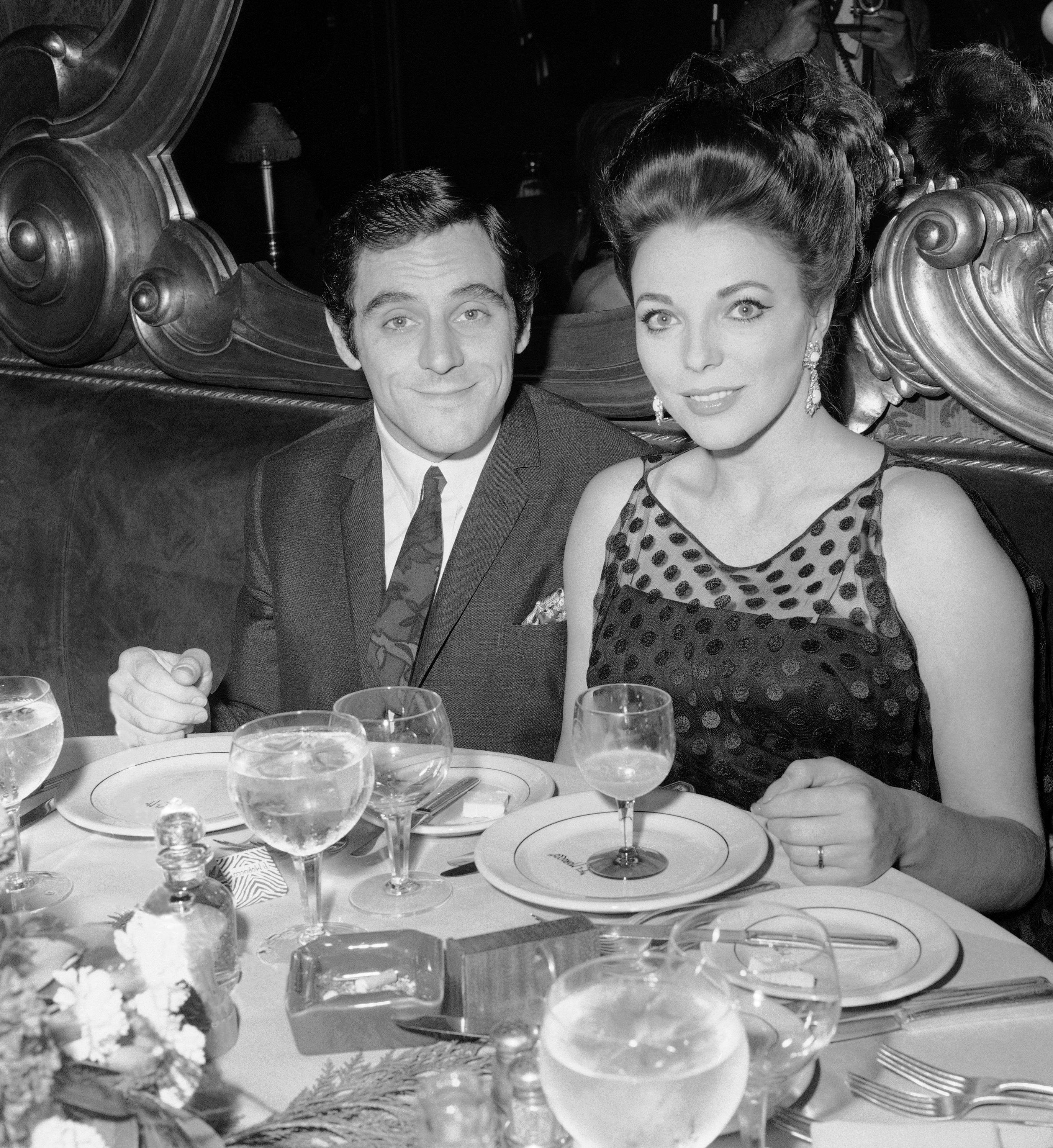 Anthony Newley star and author of British musical 'Stop the world-I want to get off' poses with his bride at New York's El Morocco May 28, 1963. Newley, currently starring on Broadway, was married May 27 to British actress Joan Collins. It was the second marriage for both. (AP Photo/Matty Zimmerman)