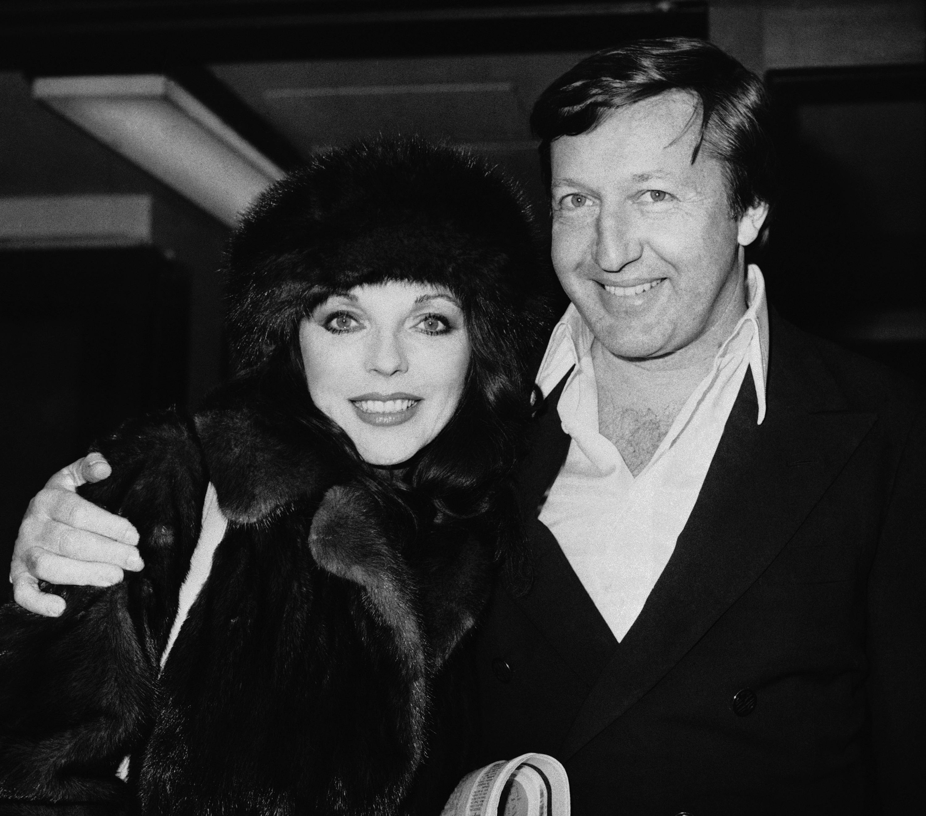 Actress Joan Collins, left, and film producer husband Ron Kass arrive at London's Heathrow Airport from Los Angeles, Feb. 16, 1978, London, England. (AP Photo)