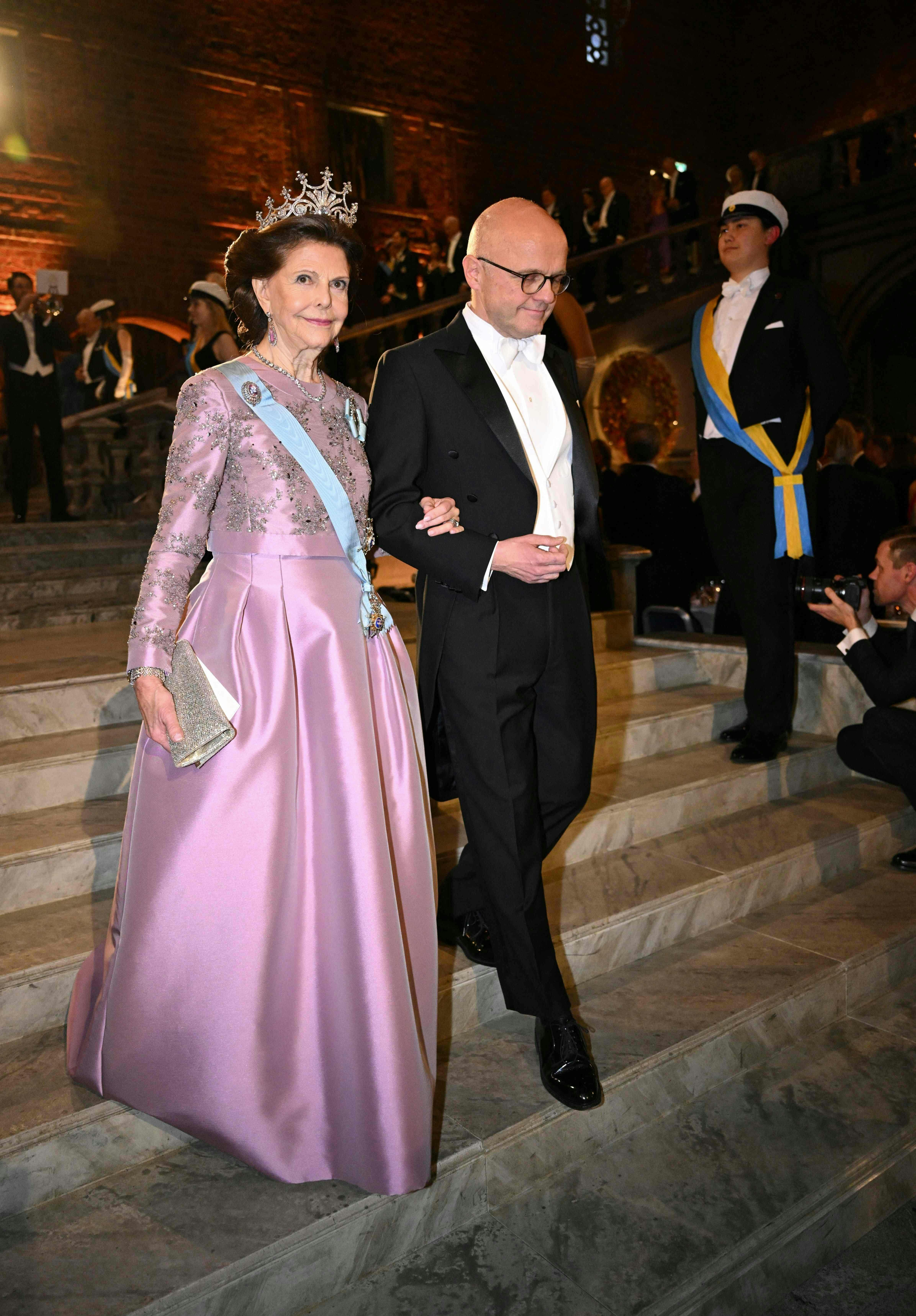 Queen Silvia of Sweden (L) arrives for the Nobel Prize Banquet at the City Hall in Stockholm, Sweden on December 10, 2023, following the Nobel awards ceremony. (Photo by Jonathan NACKSTRAND / AFP)