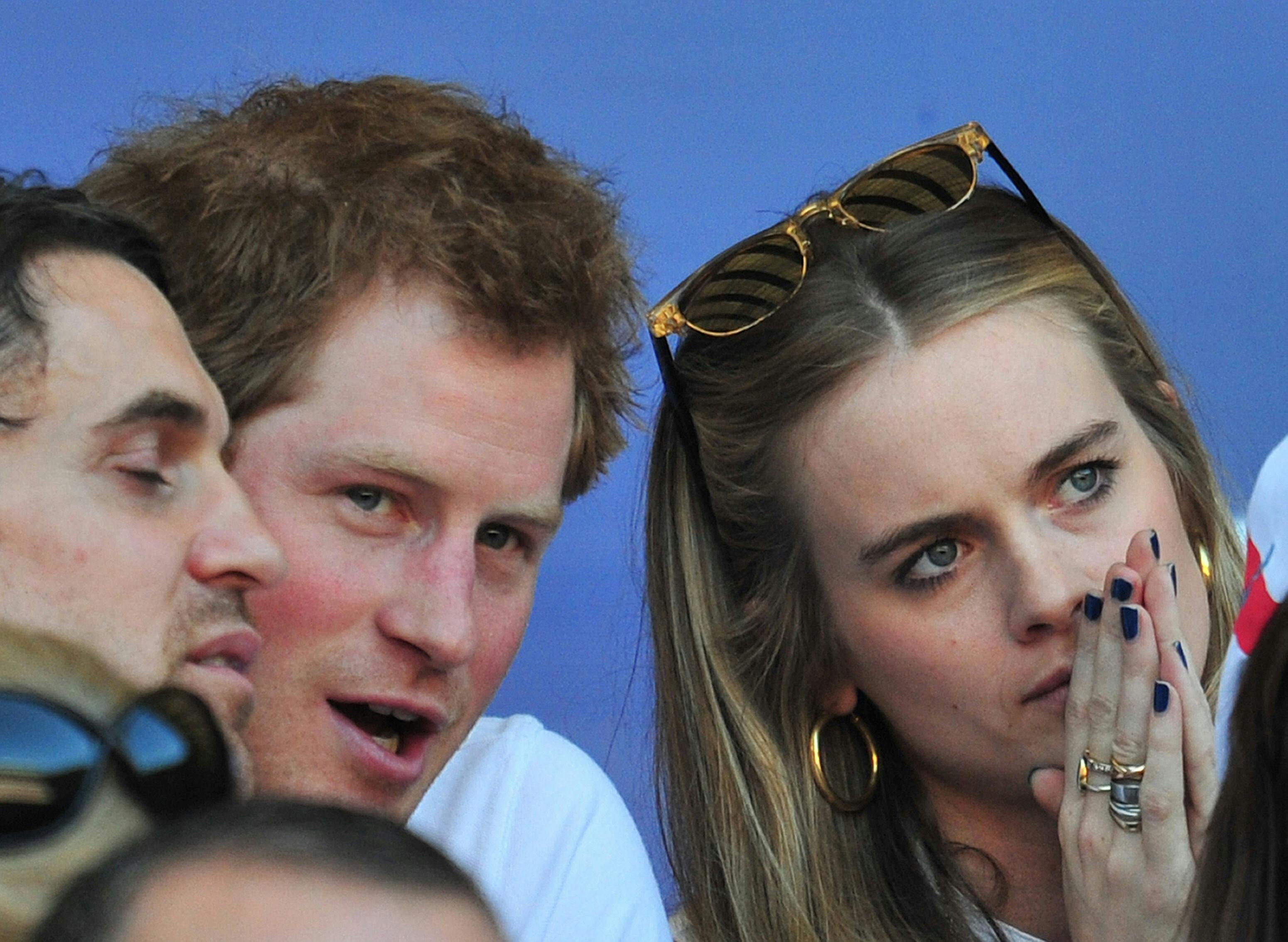 (FILES) A file picture taken in London on March 9, 2014, shows Britain's Prince Harry (L) and Cressida Bonas watching a Six Nations International rugby union match between England and Wales at Twickenham. Prince Harry and his girlfriend of nearly two years, Cressida Bonas, have split up, Britain's Daily Telegraph and US magazine People reported Tuesday April 29, 2014. AFP PHOTO / GLYN KIRK/FILES