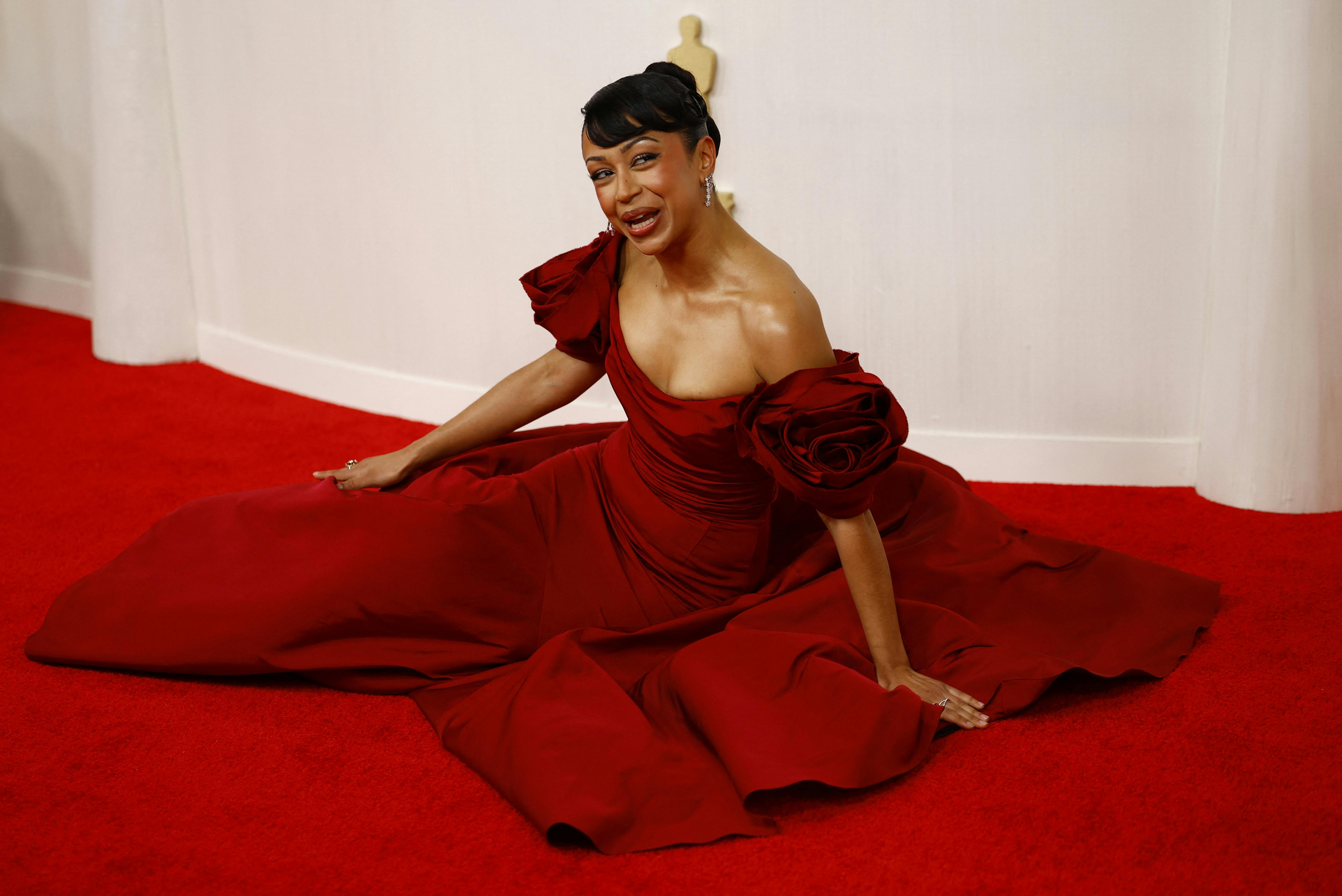 Liza Koshy lies on the ground on the red carpet during the Oscars arrivals at the 96th Academy Awards in Hollywood, Los Angeles, California, U.S., March 10, 2024. REUTERS/Sarah Meyssonnier
