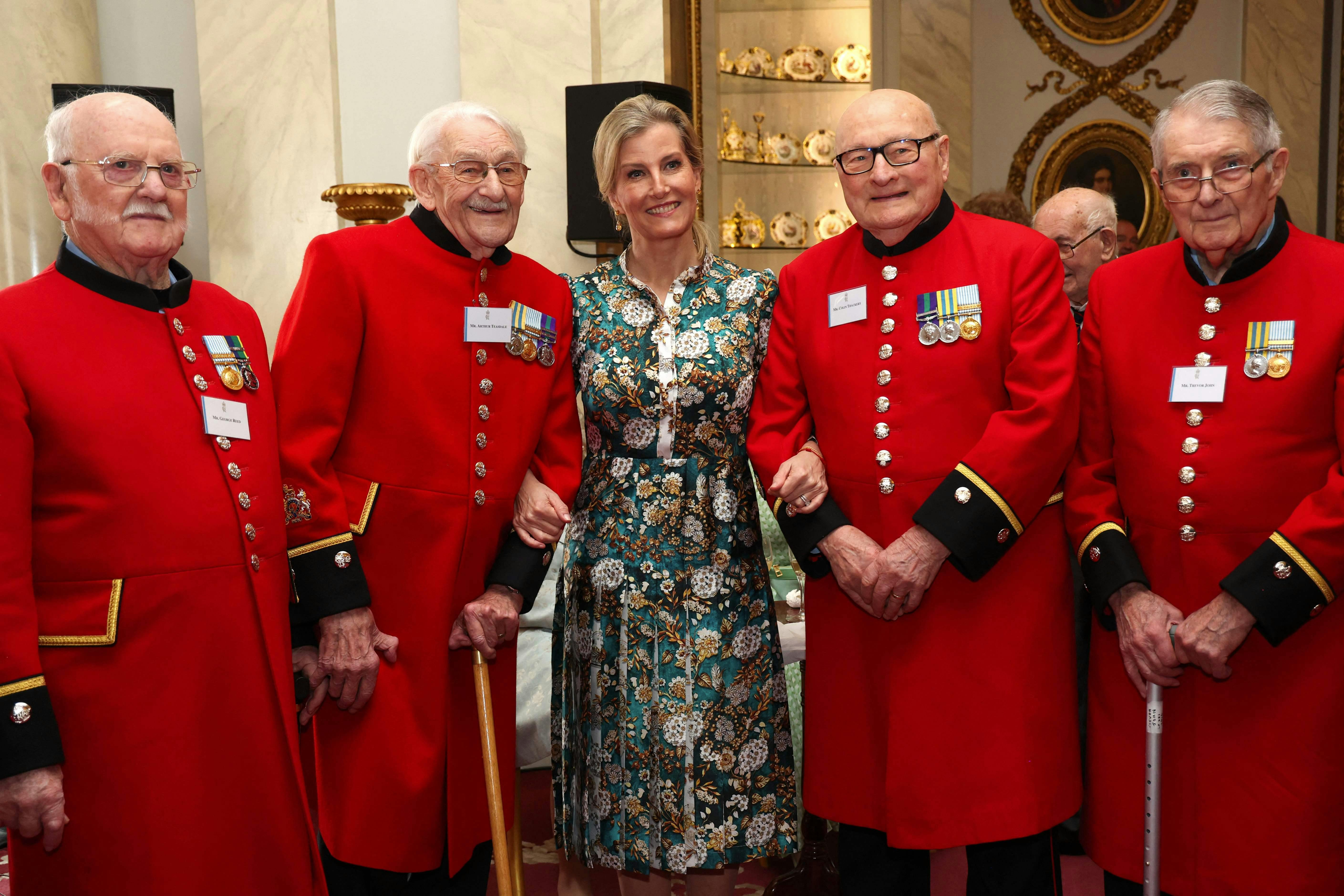 Britain's Sophie, Duchess of Edinburgh poses for a picture with Chelsea Pensioners during a reception for Korean war veterans, to mark the 70th anniversary of the Korean War, which she hosted on behalf of Britain's King Charles III at Buckingham Palace in central London on March 19, 2024. (Photo by Tristan Fewings / POOL / AFP)