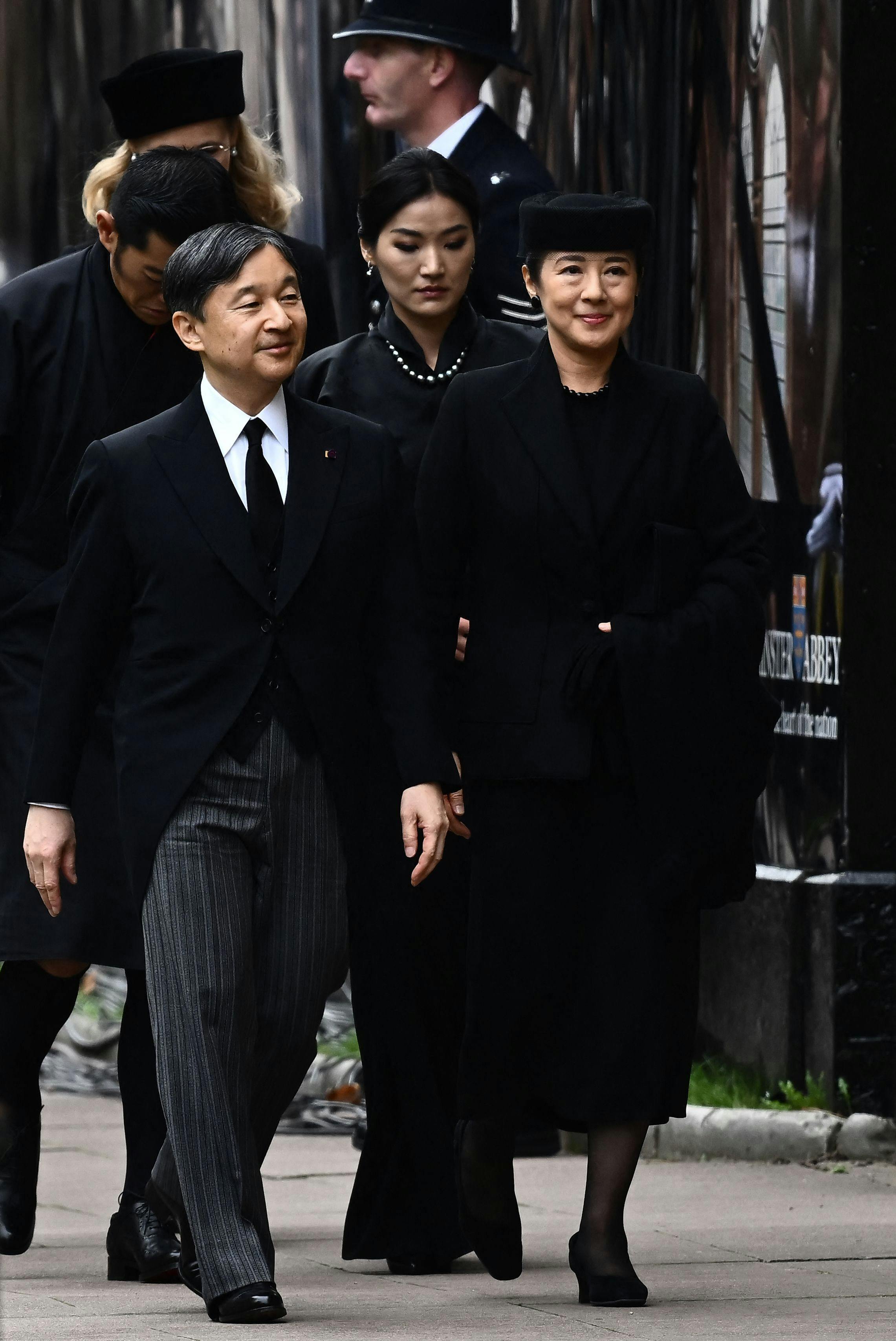 Japan's Emperor Naruhito and Japan's Empress Masako arrive to take their seats inside Westminster Abbey in London on September 19, 2022, for the State Funeral Service for Britain's Queen Elizabeth II. - Leaders from around the world will attend the state funeral of Queen Elizabeth II. The country's longest-serving monarch, who died aged 96 after 70 years on the throne, will be honoured with a state funeral on Monday morning at Westminster Abbey. (Photo by Marco BERTORELLO / AFP)