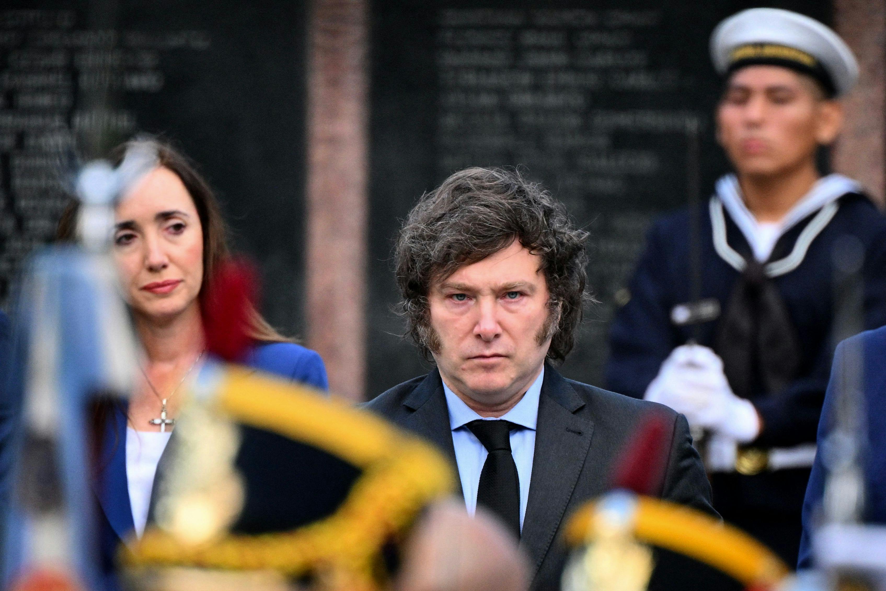 Argentina's President Javier Milei (C) and his vice president Victoria Villaruel (L) take part in a ceremony to commemorate the 42nd anniversary of the war between Argentina and the United Kingdom over the Malvinas/Falkland islands, at the Cenotaph to the Fallen of the Malvinas War in Buenos Aires, on April 2, 2024. (Photo by Luis ROBAYO / AFP)
