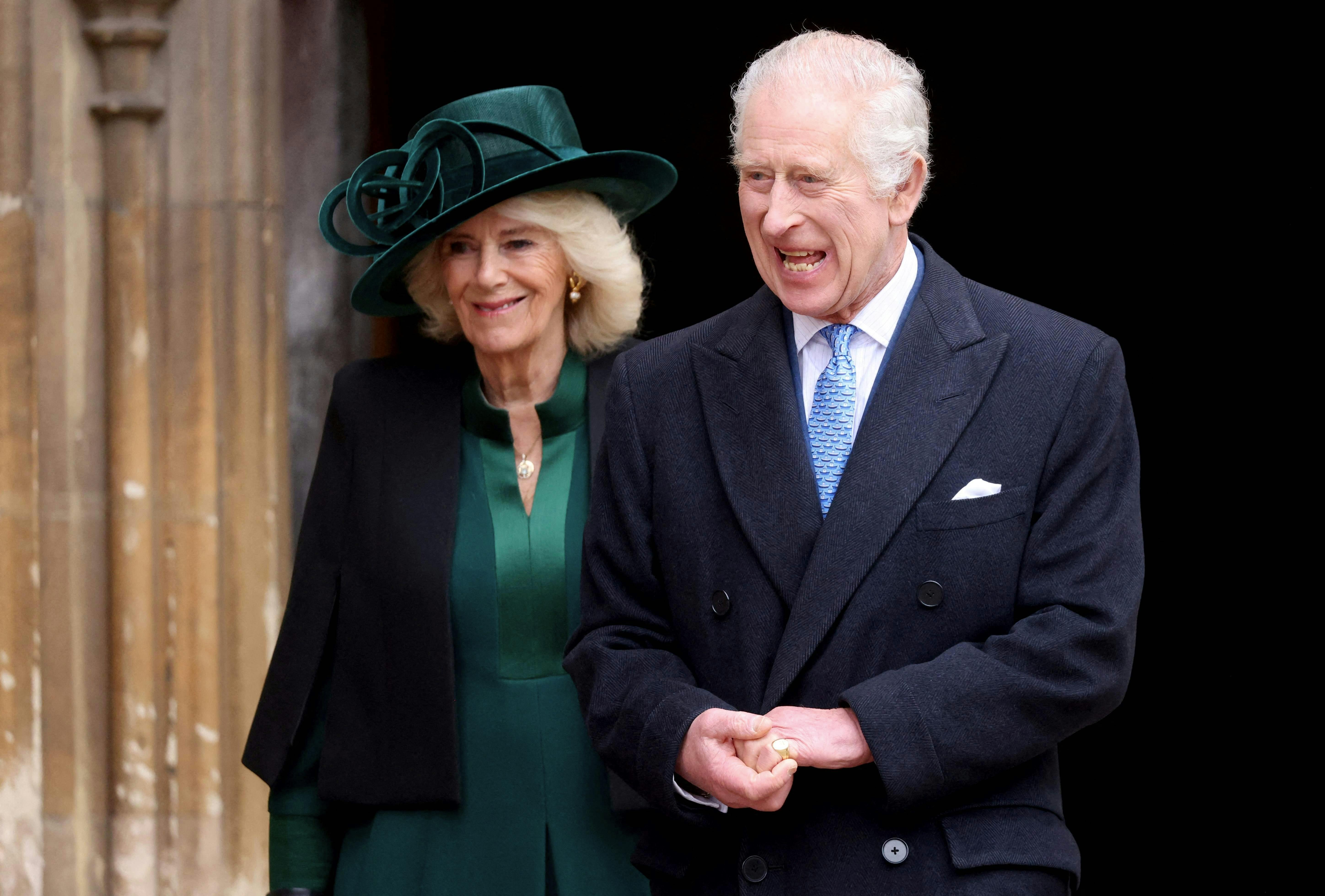 Britain's King Charles III (front R), followed by Britain's Queen Camilla (rear L), reacts as he leaves St. George's Chapel, in Windsor Castle, after attending the Easter Mattins Service, on March 31, 2024. (Photo by Hollie Adams / POOL / AFP)