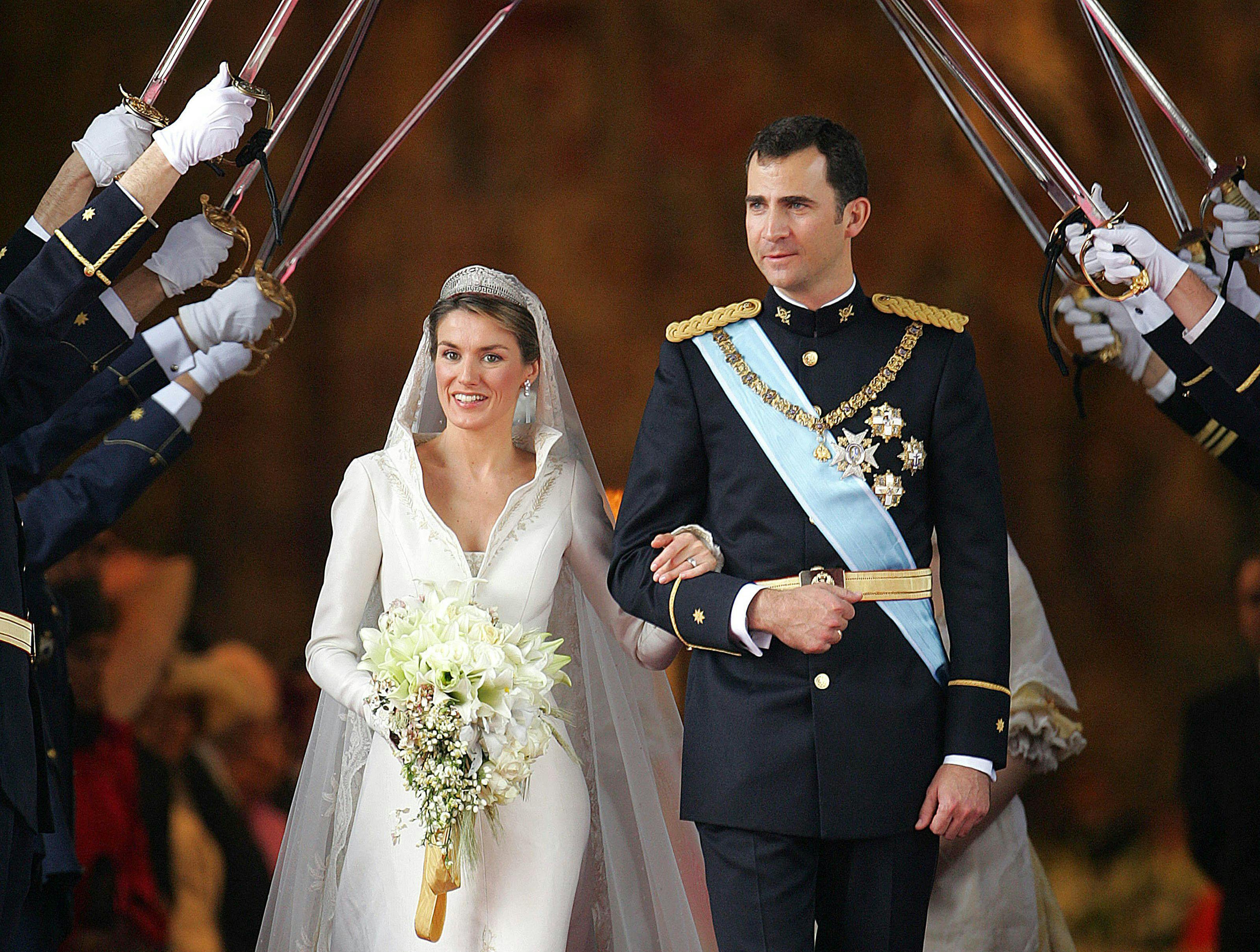 (FILES) Princess of Asturias Letizia Ortiz and Spanish Crown Felipe of Bourbon leave Madrid's Almudena Cathedral at the end of their wedding ceremony 22 May 2004. Spain's King Felipe VI and Queen Letizia will celebrate their 20th wedding anniversary on May 22, 2024, with the couple widely praised for having regenerated the scandal-tainted monarchy's ways for a new era. (Photo by Odd ANDERSEN / POOL / AFP)