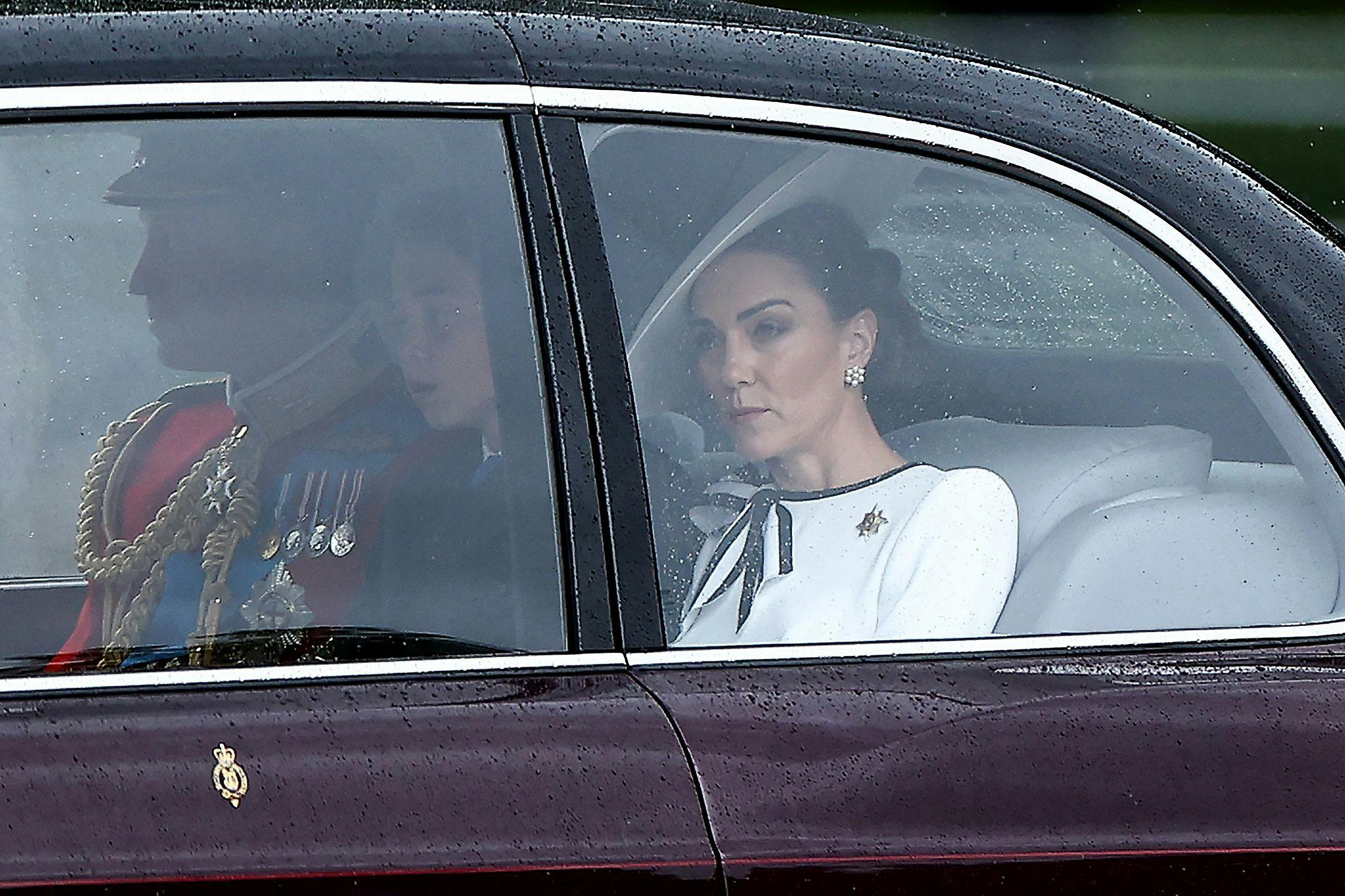 Britain's Catherine, Princess of Wales, (R) arrives with Britain's Prince William, Prince of Wales, (L) and Britain's Prince George of Wales (C) to Buckingham Palace before the King's Birthday Parade "Trooping the Colour" in London on June 15, 2024. Catherine, Princess of Wales, is making a tentative return to public life for the first time since being diagnosed with cancer, attending the Trooping the Colour military parade in central London. (Photo by HENRY NICHOLLS / AFP)