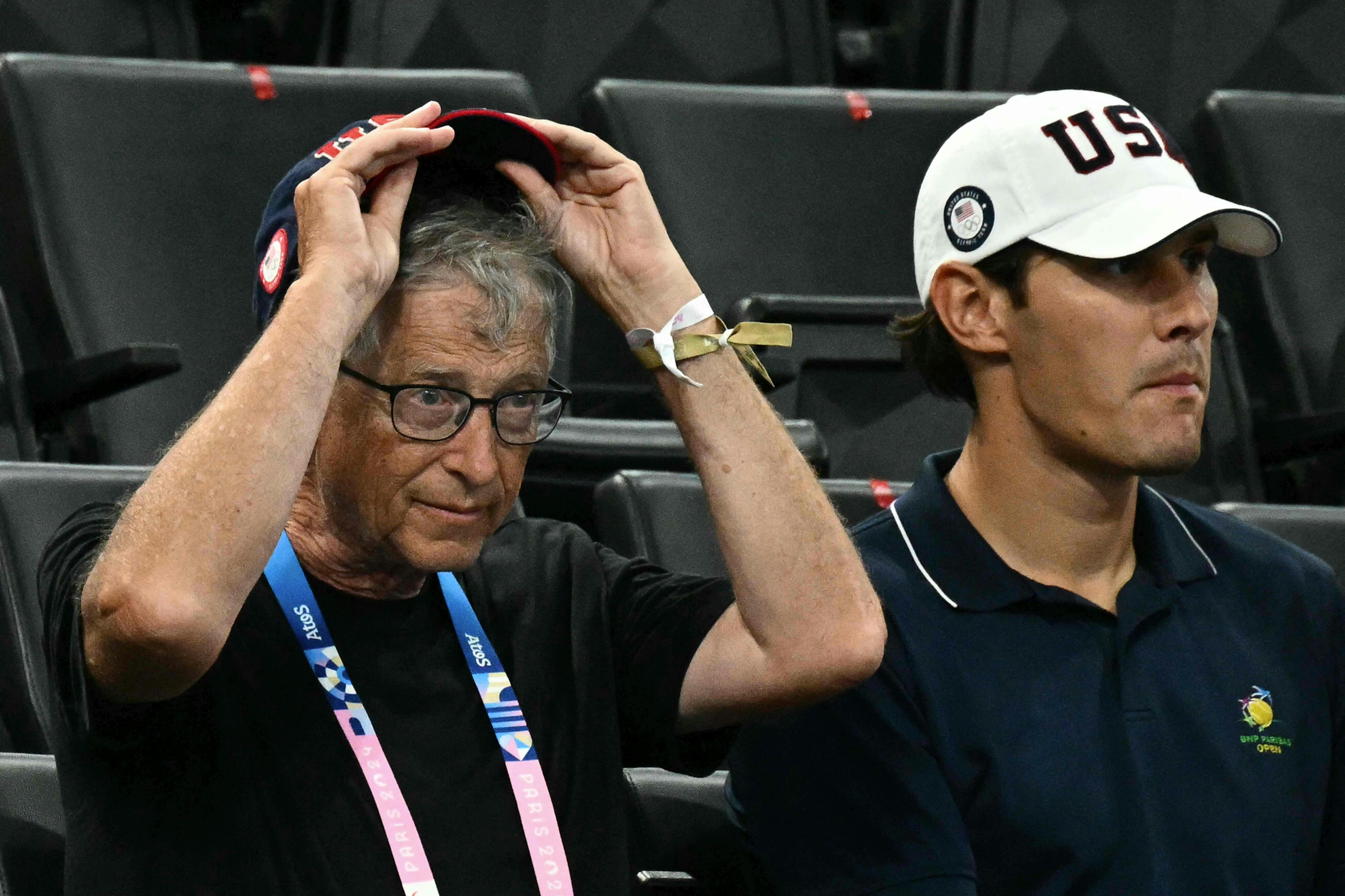 US businessman Bill Gates (L) waits for the start of the artistic gymnastics women's team final during the Paris 2024 Olympic Games at the Bercy Arena in Paris, on July 30, 2024. (Photo by Loic VENANCE / AFP)