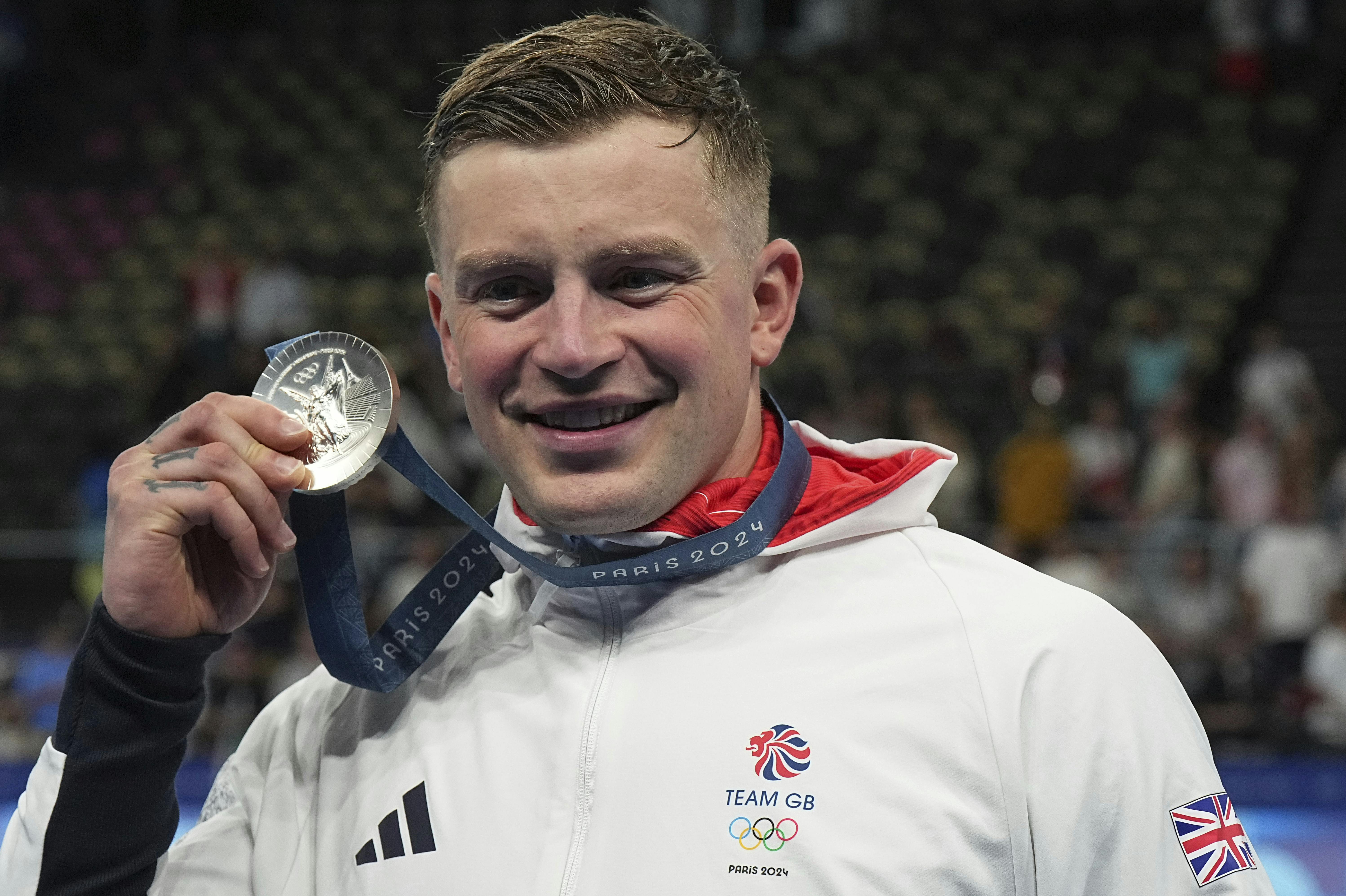 28 July 2024, France, Paris: Olympics, Paris 2024, Swimming, Paris La Defense Arena, 100 m breaststroke, men, final, runner-up Adam Peaty from Great Britain celebrates at the award ceremony. Photo by: Michael Kappeler/picture-alliance/dpa/AP Images