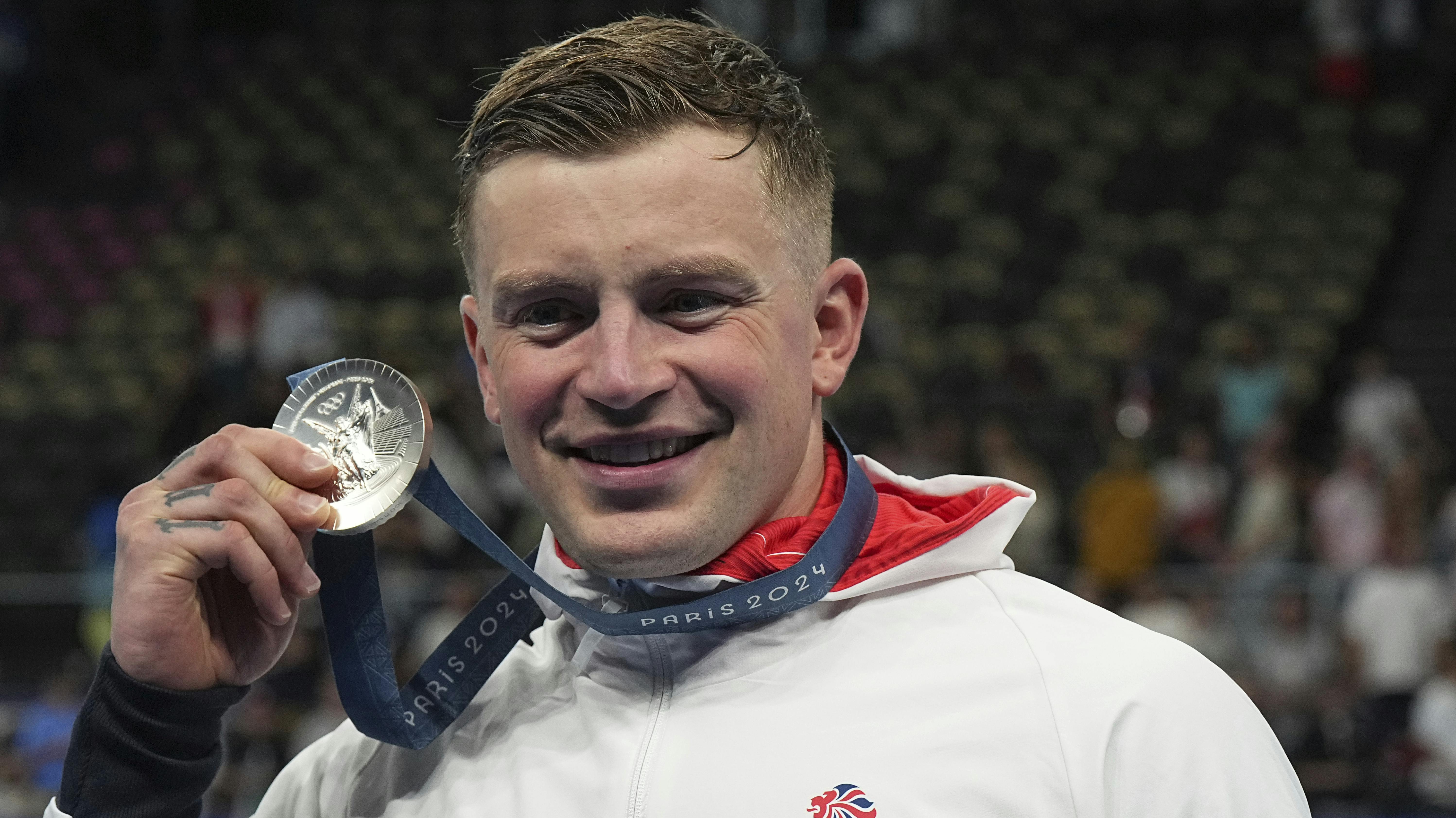28 July 2024, France, Paris: Olympics, Paris 2024, Swimming, Paris La Defense Arena, 100 m breaststroke, men, final, runner-up Adam Peaty from Great Britain celebrates at the award ceremony. Photo by: Michael Kappeler/picture-alliance/dpa/AP Images