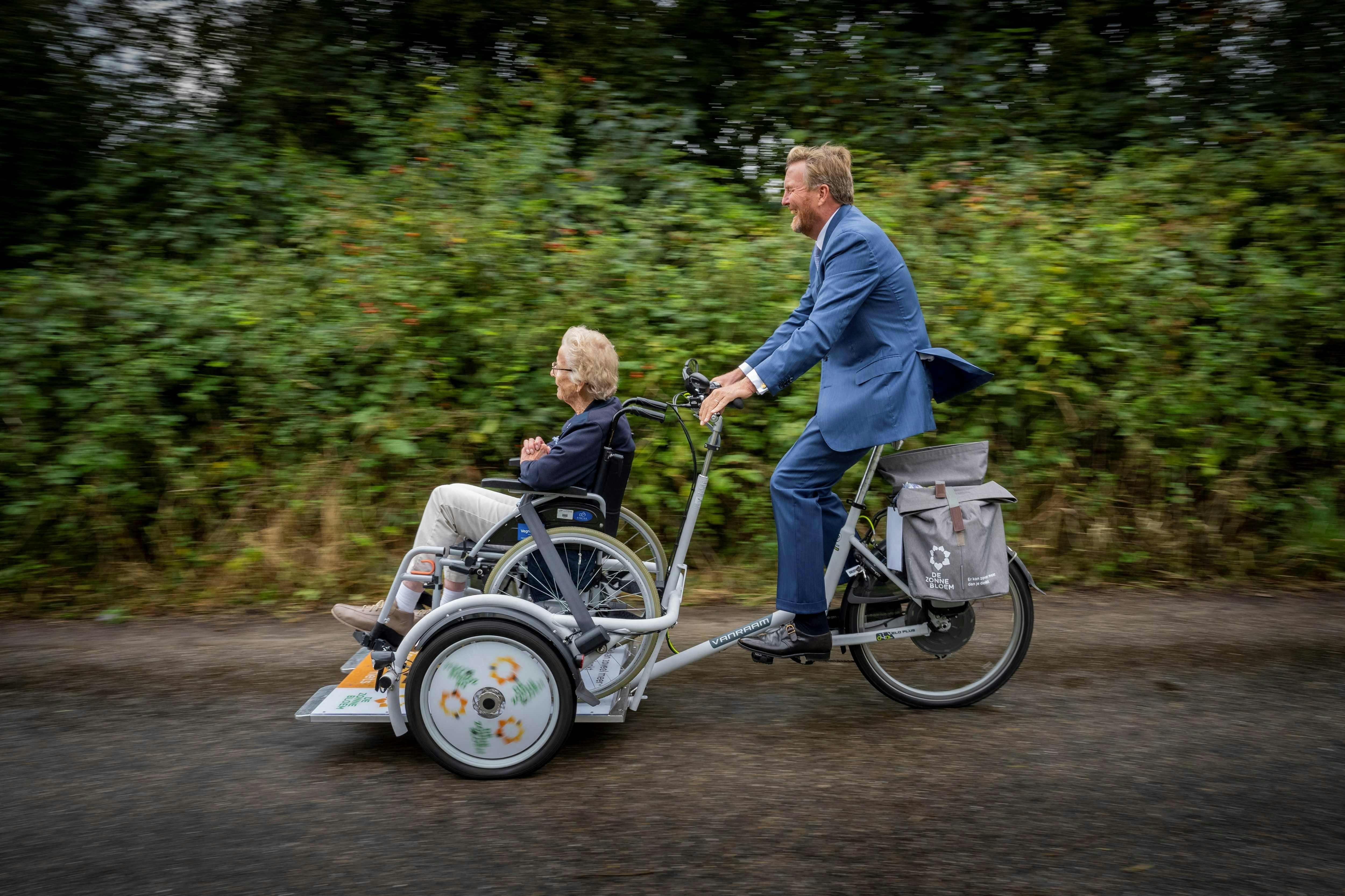 Dutch King Willem-Alexander rides during a celebration for the 75th anniversary of the National Association de Zonnebloem, which works with people with physical disabilities in Mirns on September 4, 2024. (Photo by Jilmer Postma / ANP / AFP) / Netherlands OUT