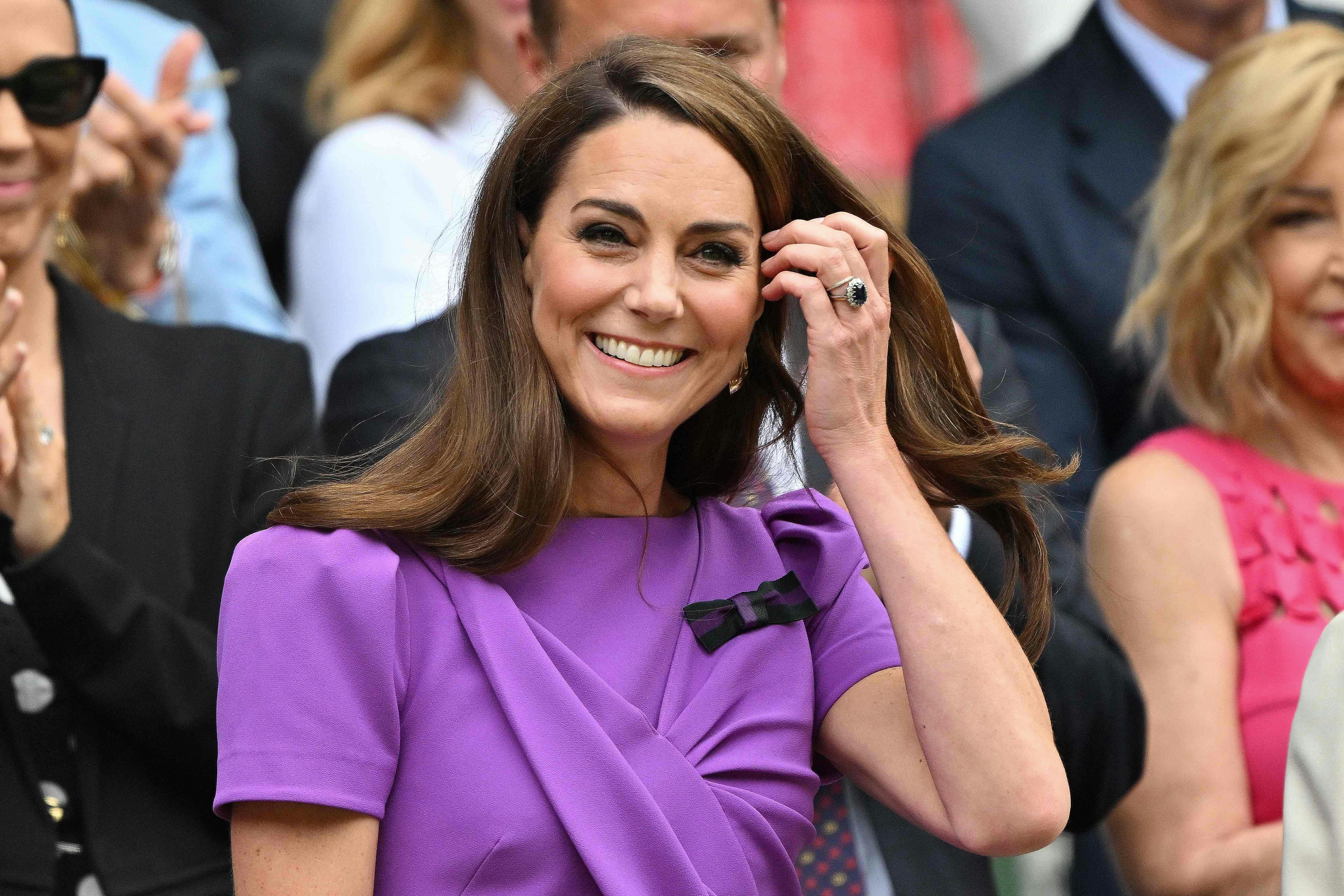 TOPSHOT - Britain's Catherine, Princess of Wales reacts as she arrives in the Royal Box on Centre Court to attend the men's singles final tennis match on the fourteenth day of the 2024 Wimbledon Championships at The All England Lawn Tennis and Croquet Club in Wimbledon, southwest London, on July 14, 2024. (Photo by ANDREJ ISAKOVIC / AFP) / RESTRICTED TO EDITORIAL USE