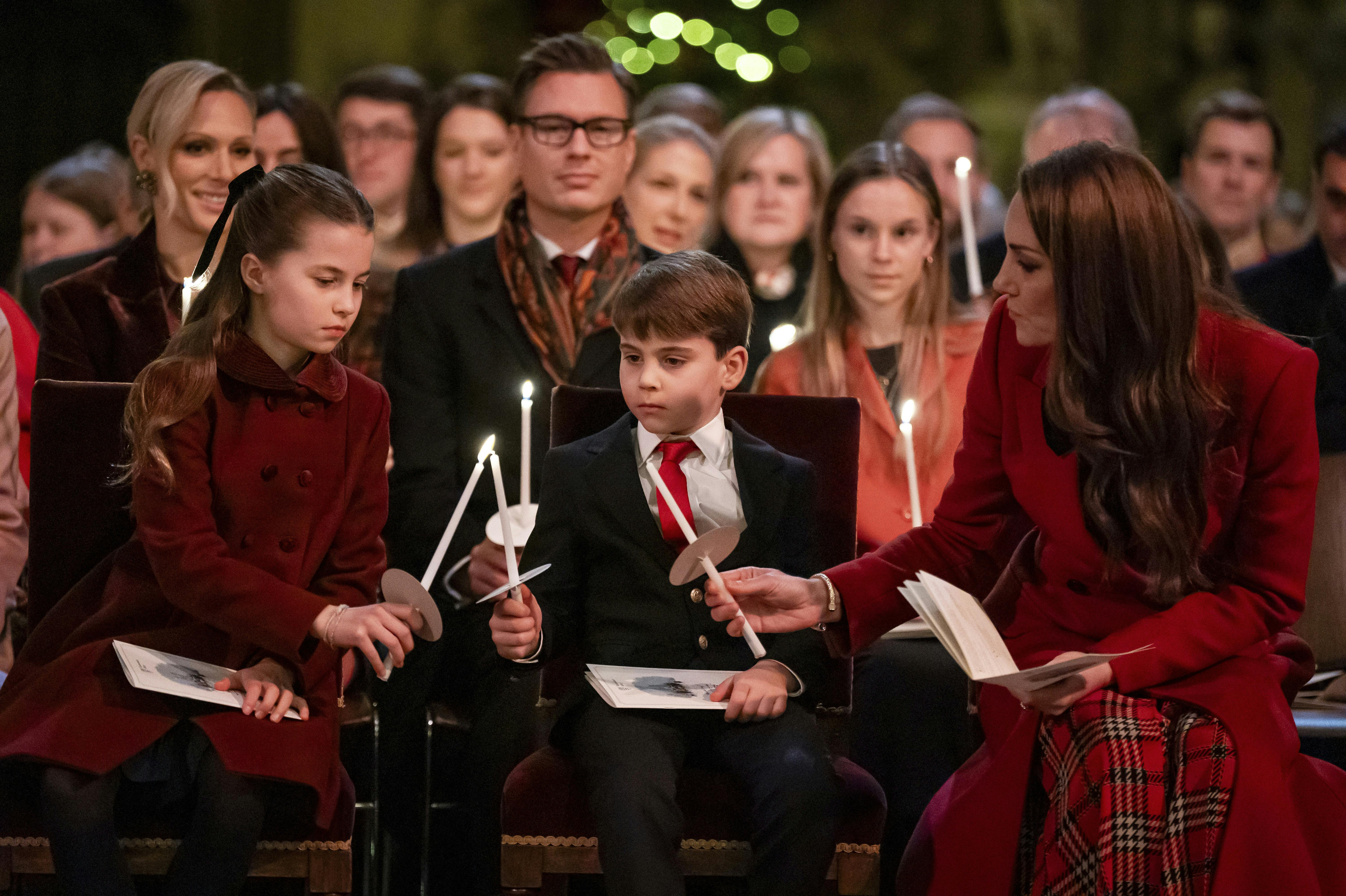 Britain's Princess Charlotte, from left, Prince Louis and Britain's Kate, the Princess of Wales, during the Together At Christmas carol service at Westminster Abbey, in London, Friday, Dec. 6, 2024. (Aaron Chown/Pool Photo via AP)