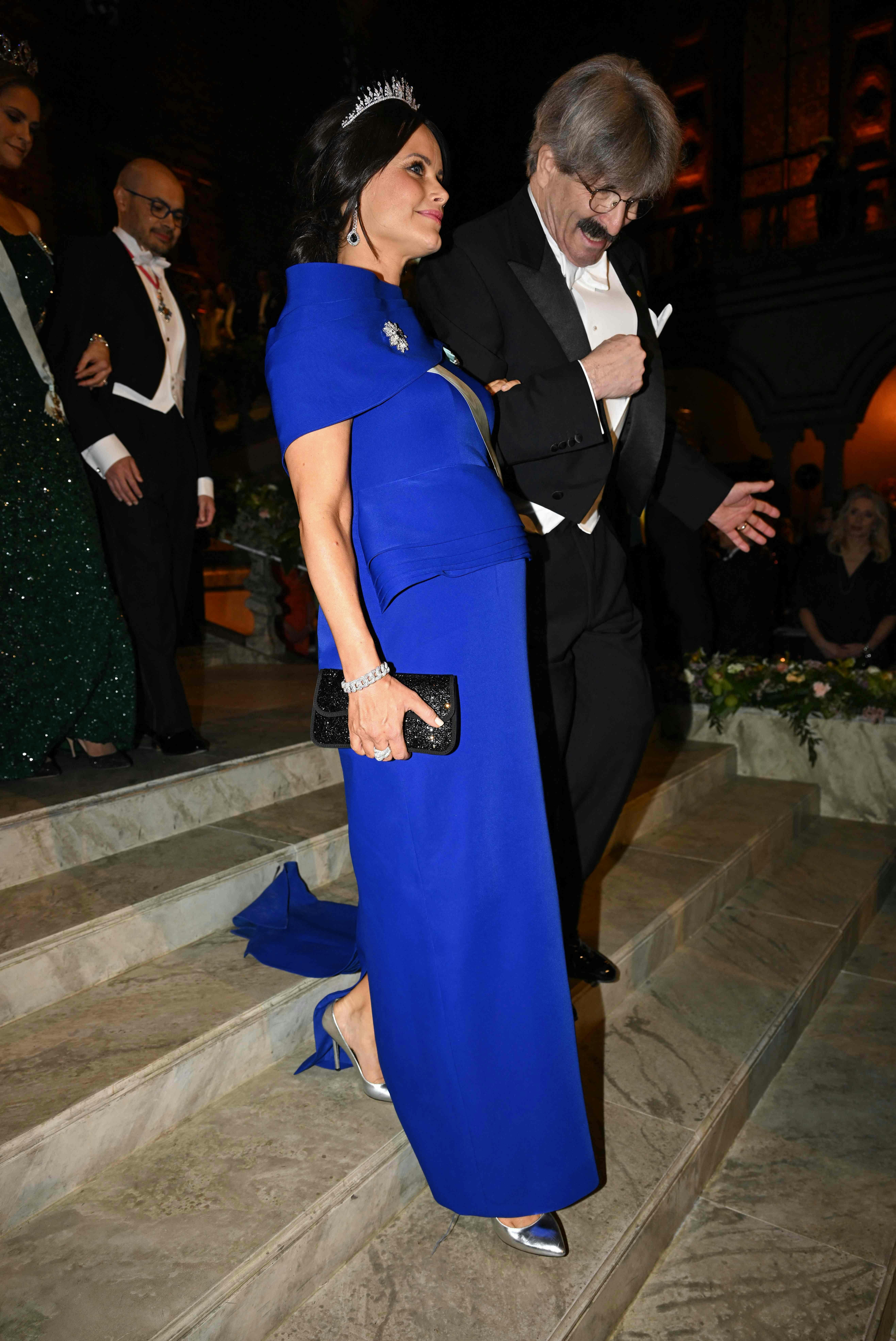 Nobel Prize in Physiology or Medicine 2024 laureate and US molecular biologist Gary Ruvkun (R) arrives with Princess Sofia of Sweden for the Nobel Prize banquet at the City Hall in Stockholm, Sweden on December 10, 2024. (Photo by Jonathan NACKSTRAND / AFP)