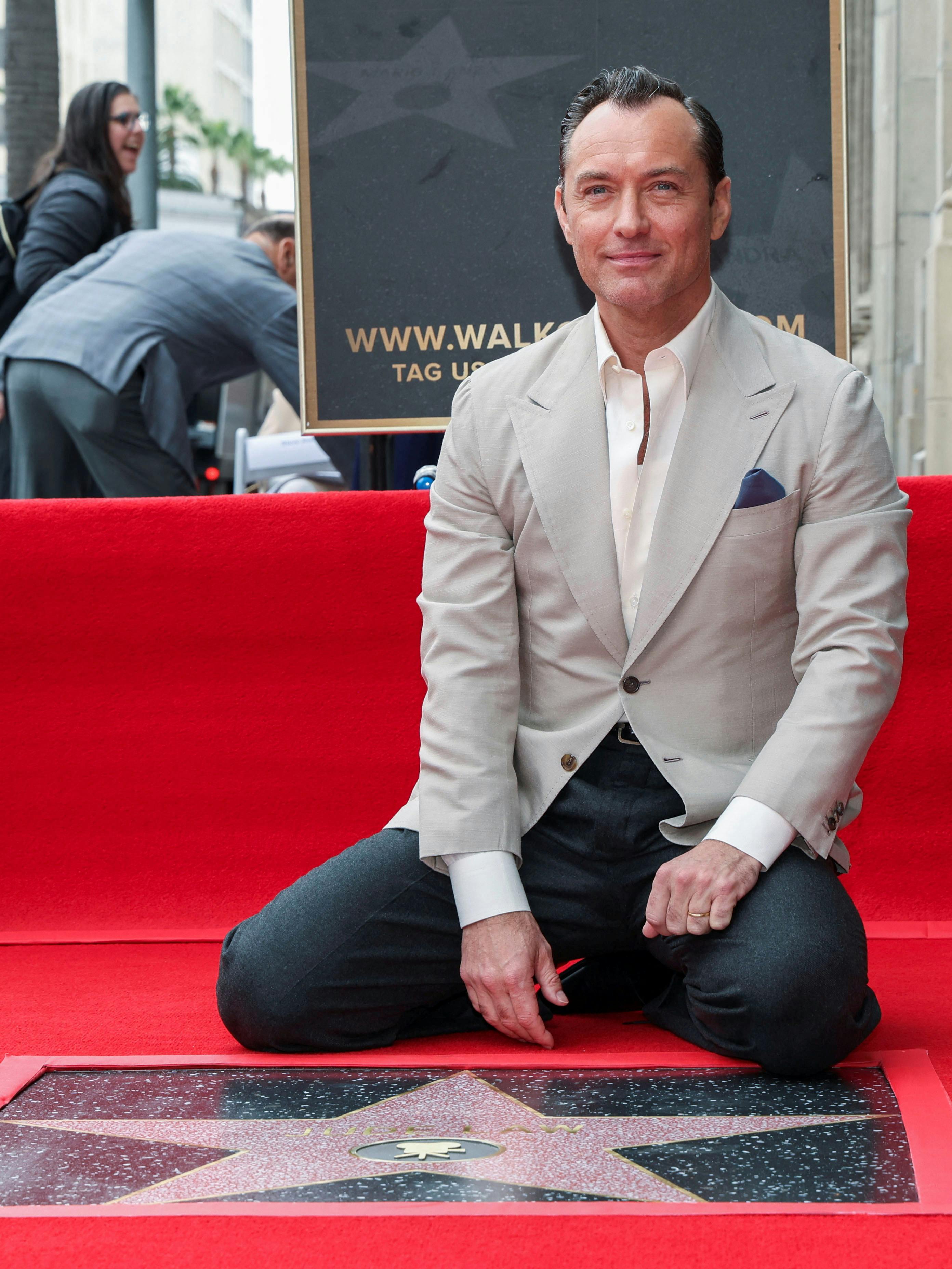 Actor Jude Law poses with his star on the day he unveiled it, on The Hollywood Walk of Fame in Los Angeles, California, U.S. December 12, 2024. REUTERS/Mario Anzuoni