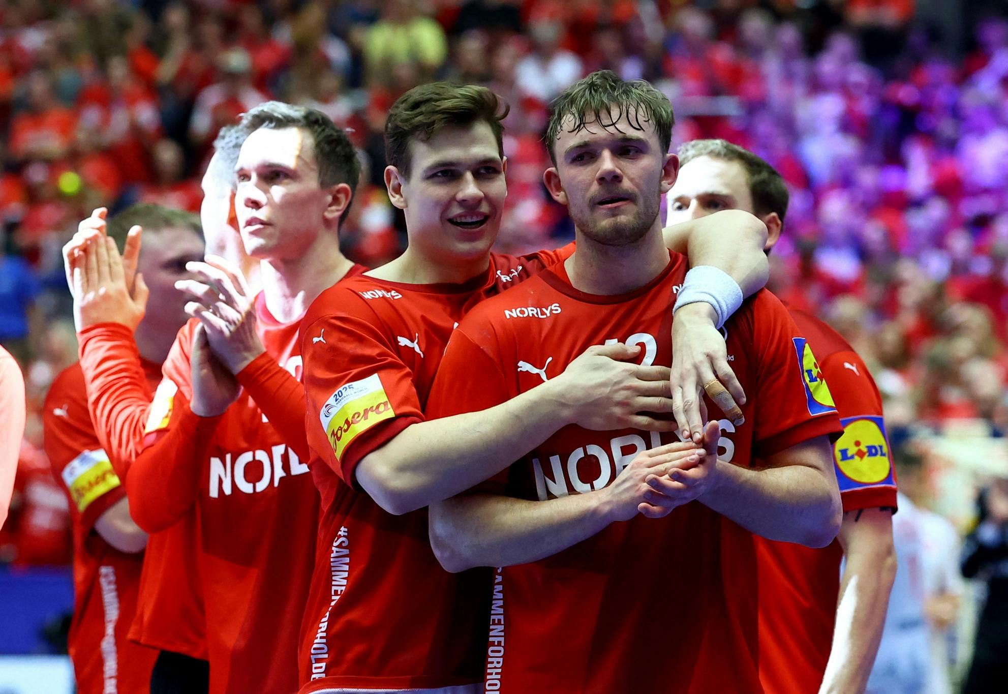 Handball - IHF Handball World Championships 2025 - Main Round I - Denmark v Switzerland - Jyske Bank Boxen, Herning, Denmark - January 23, 2025 Denmark's Thomas Arnoldsen and Lukas Jorgensen celebrate after the match REUTERS/Bernadett Szabo