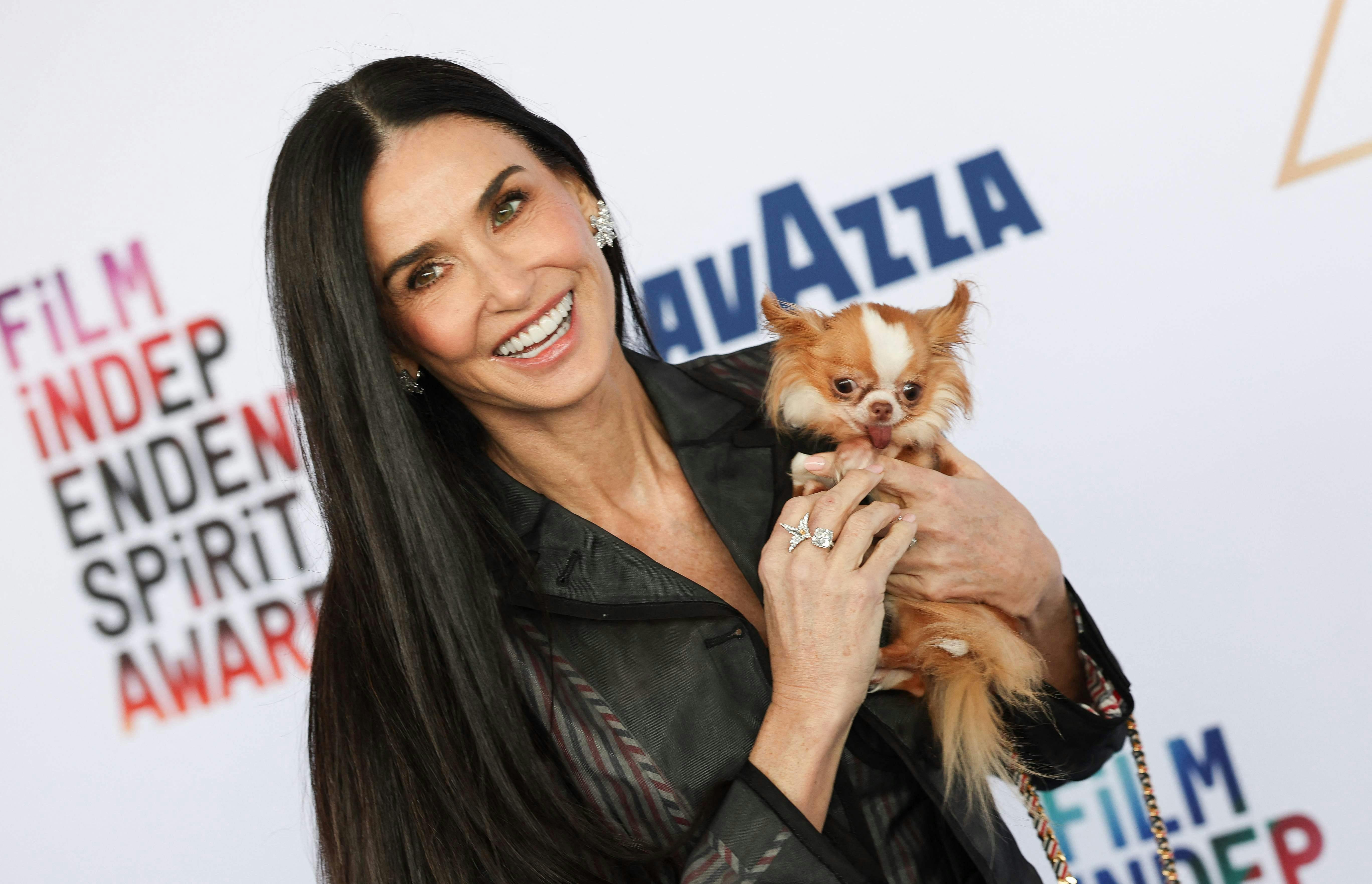 TOPSHOT - US actress Demi Moore and her dog Pilaf arrive for the Film Independent Spirit Awards 40th annual ceremony in Santa Monica, California, February 22, 2025. (Photo by Valerie MACON / AFP)