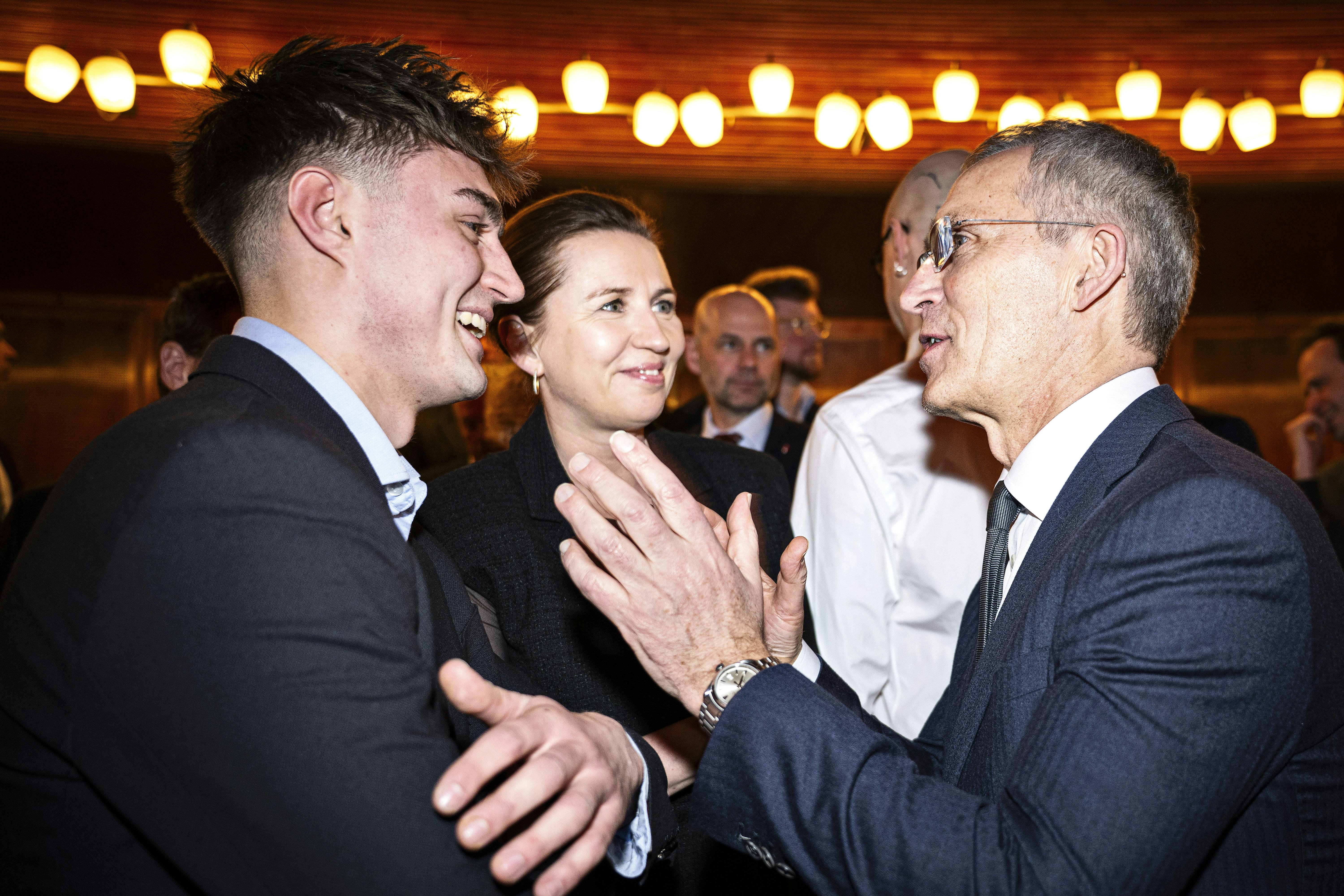 Norwegian Finance Minister Jens Stoltenberg speaks with Prime Minister Mette Frederiksen's son Magne Frederiksen while Mette Frederiksen looks on as they arrive at the documentary film festival CPH:DOX' opening gala at the Conservatory Concert Hall in Frederiksberg on Wednesday, March 19, 2025. The opening film "Facing War" depicts Jens Stoltenberg's last year as NATO Secretary General. (Photo: Nils Meilvang/Scanpix 2025)