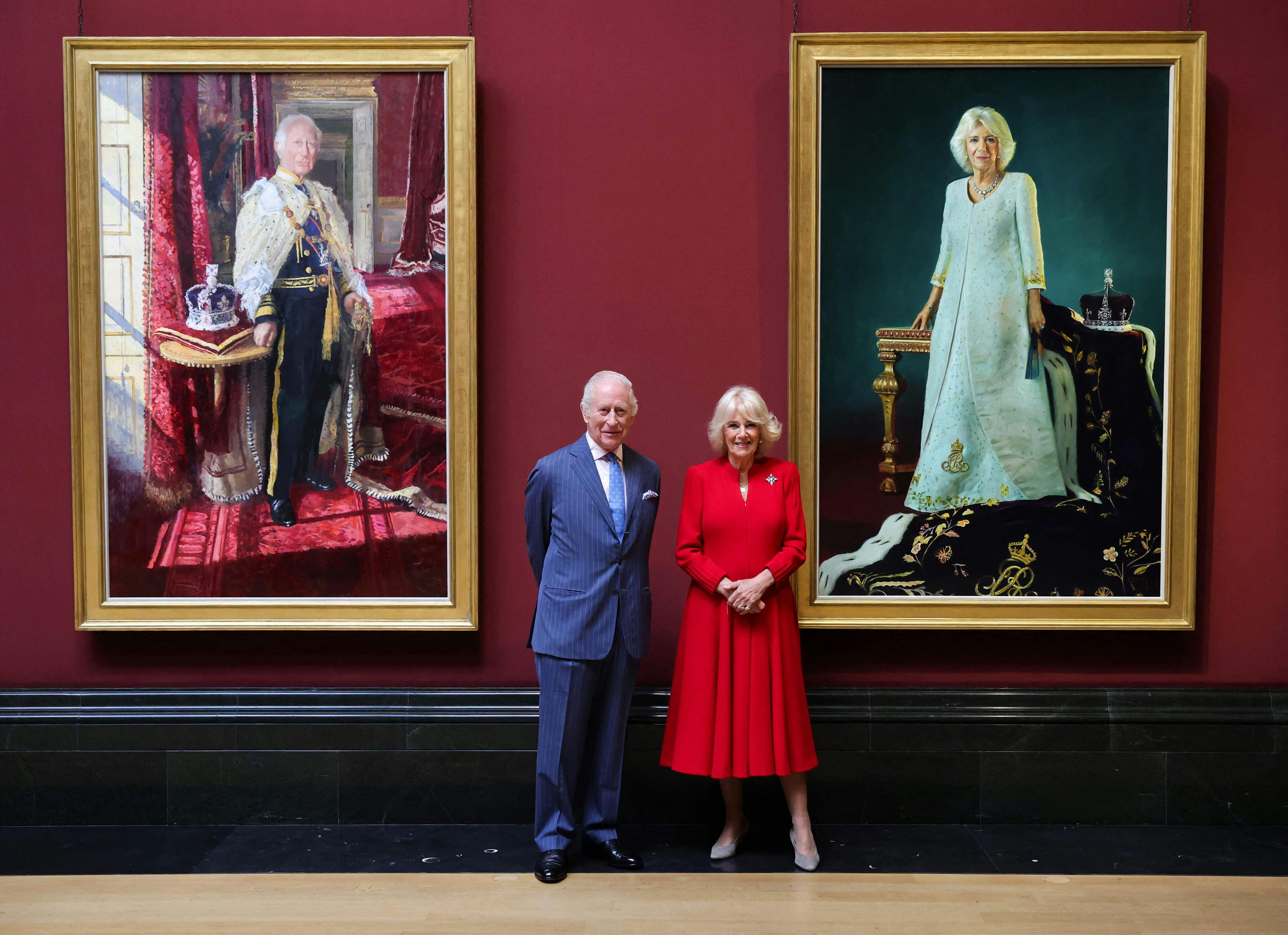 Britain's King Charles III and Britain's Queen Camilla pose with their official Coronation State Portraits, with the King's painted by artist Peter Kuhfeld, and the Queen's by artist Paul S. Benney, during a visit to The National Gallery, in central London, on May 6, 2025. (Photo by Chris Jackson / POOL / AFP) / RESTRICTED TO EDITORIAL USE - MANDATORY MENTION OF THE ARTIST UPON PUBLICATION - TO ILLUSTRATE THE EVENT AS SPECIFIED IN THE CAPTION
