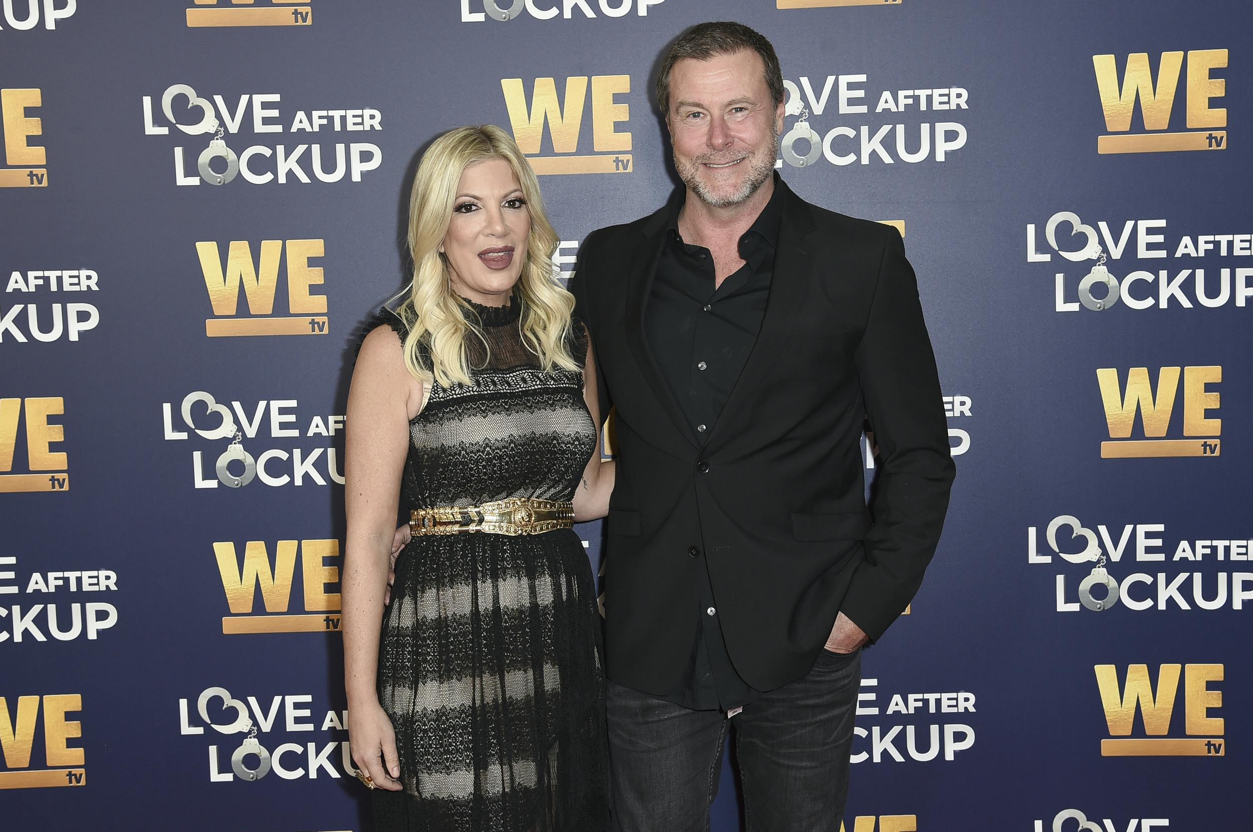 FILE - Tori Spelling, left, and Dean McDermott attend Real Love: Relationship Reality TV's Past, Present and Future on Dec. 11, 2018, in Beverly Hills, Calif. Spelling filed for divorce Friday from her husband and former reality TV co-star McDermott. The former 'Beverly Hills 90210' actor petitioned to end the marriage of nearly 18 years in Los Angeles Superior Court. She cited irreconcilable differences as the reason. (Photo by Richard Shotwell/Invision/AP, File)