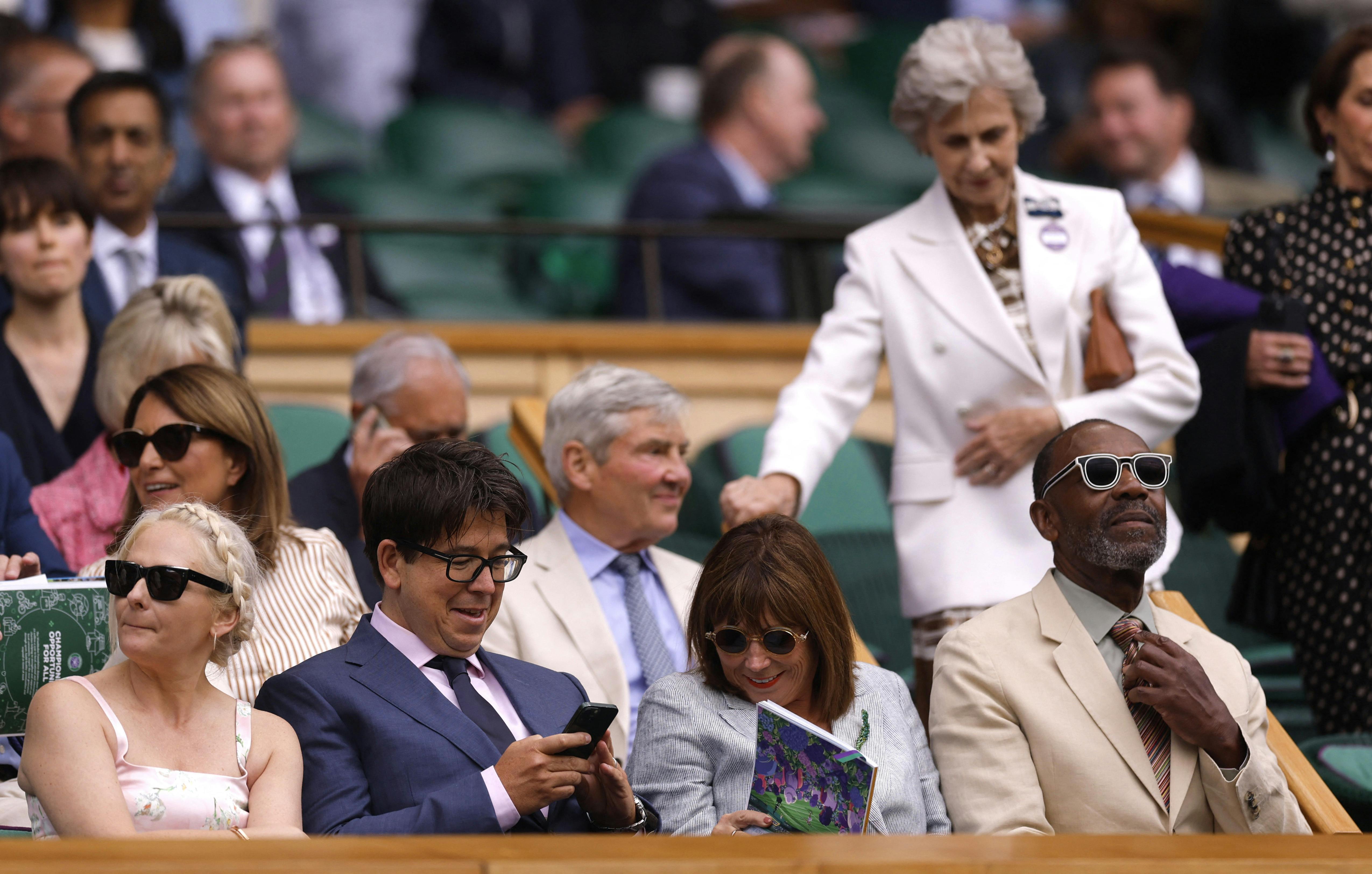 Tennis - Wimbledon - All England Lawn Tennis and Croquet Club, London, Britain - July 7, 2025 Comedian Michael McIntyre and his wife Kitty McIntyre with Lenny Henry and Lisa Makin in the Royal Box at the center court ahead of the round of 16 match between Australia's Alex de Minaur and Serbia's Novak Djokovic REUTERS/Andrew Couldridge