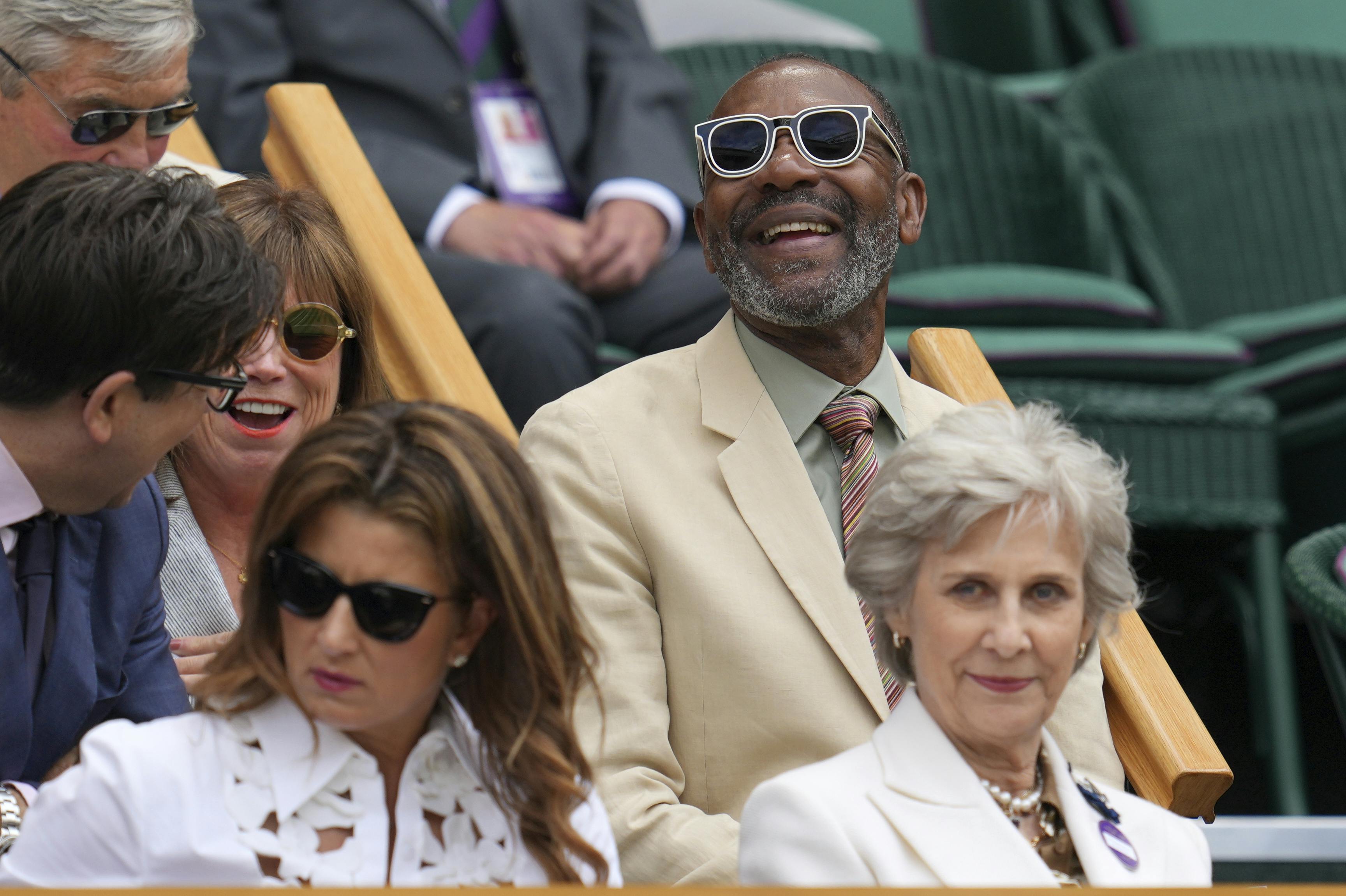 Comedian, writer and broadcaster Sir Lenny Henry, top right, sits in the Royal Box on Centre Court on day eight of the Wimbledon Tennis Championships in London, Monday, July 7, 2025. (AP Photo/Kin Cheung)