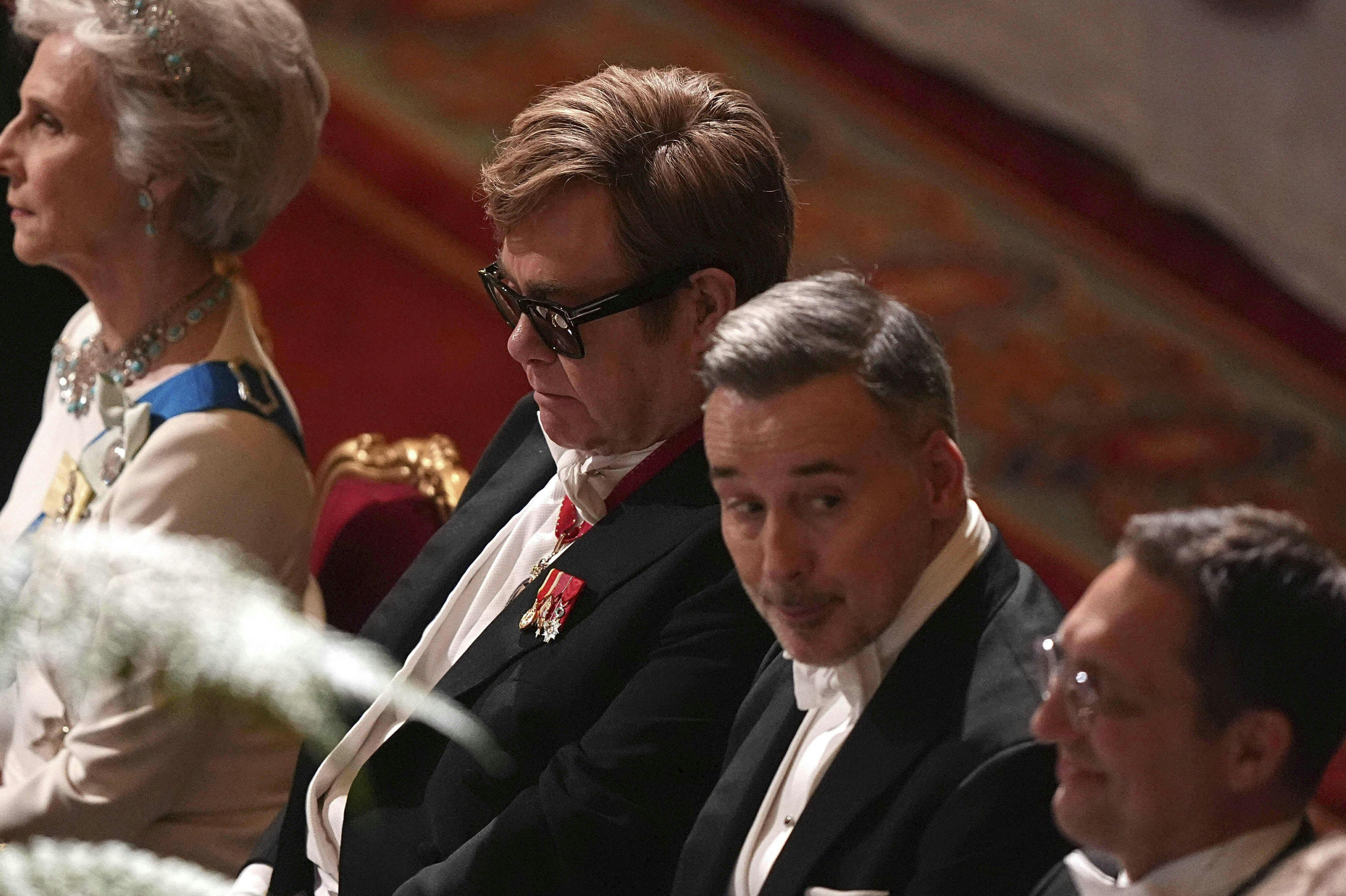 Elton John, left, and David Furnish attend the State Banquet for the President of France Emmanuel Macron, and his wife Brigitte Macron, at Windsor Castle, in Windsor, England, Tuesday, July 8, 2025. (Aaron Chown/Pool Photo via AP)