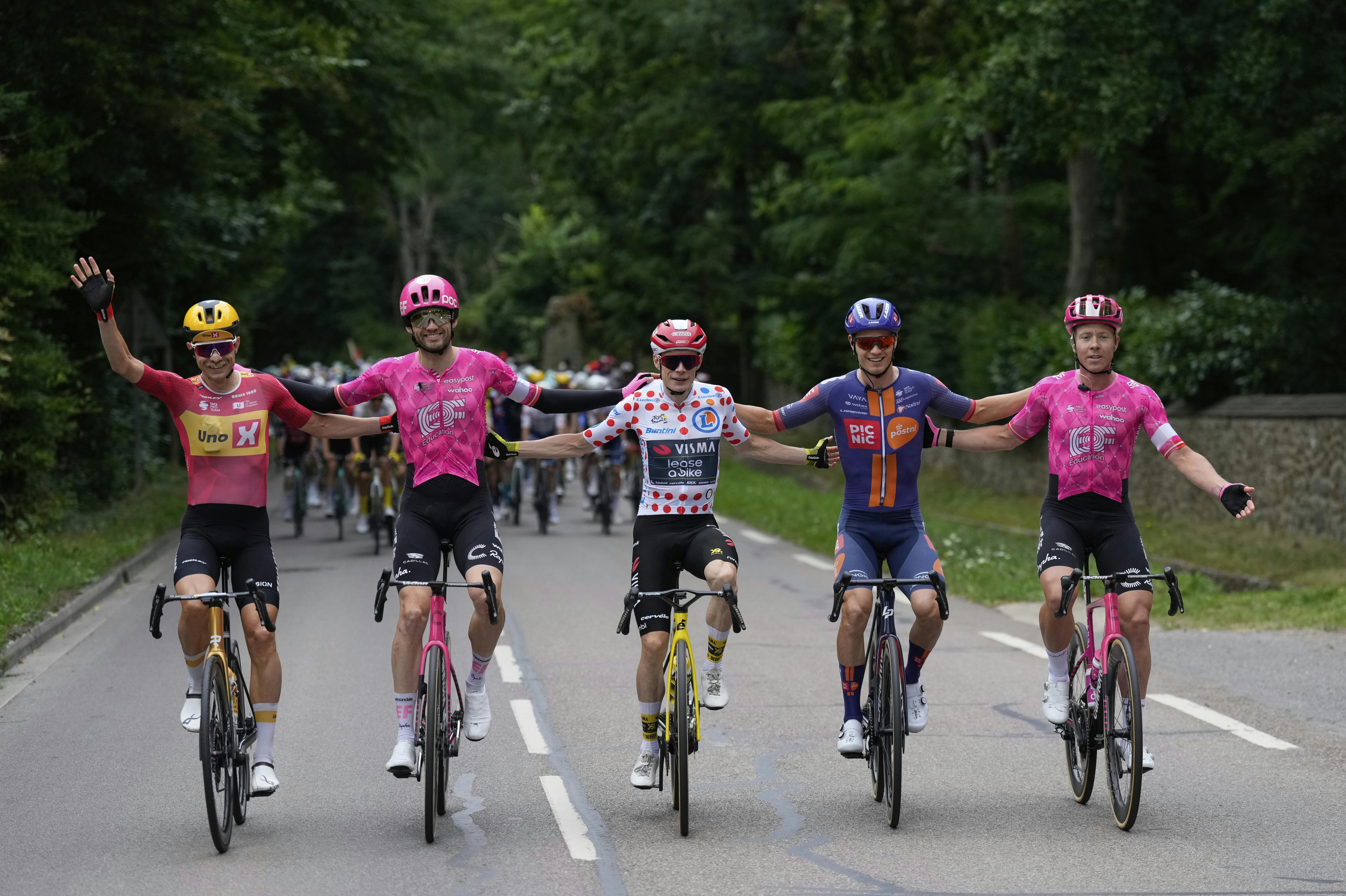 Danish riders from left, Denmark's Magnus Cort Nielsen, Denmark's Michael Valgren, Denmark's Jonas Vingegaard, wearing the best climber's dotted jersey, Denmark's Tobias Lund Andresen, and Denmark's Kasper Asgreen, celebrate during the twenty-first stage of the Tour de France cycling race over 132.3 kilometers (82.1 miles) with start in Mantes-la-Ville and finish on the Champs-Elysees in Paris, France, Sunday, July 27, 2025. (AP Photo/Mosa'ab Elshamy)