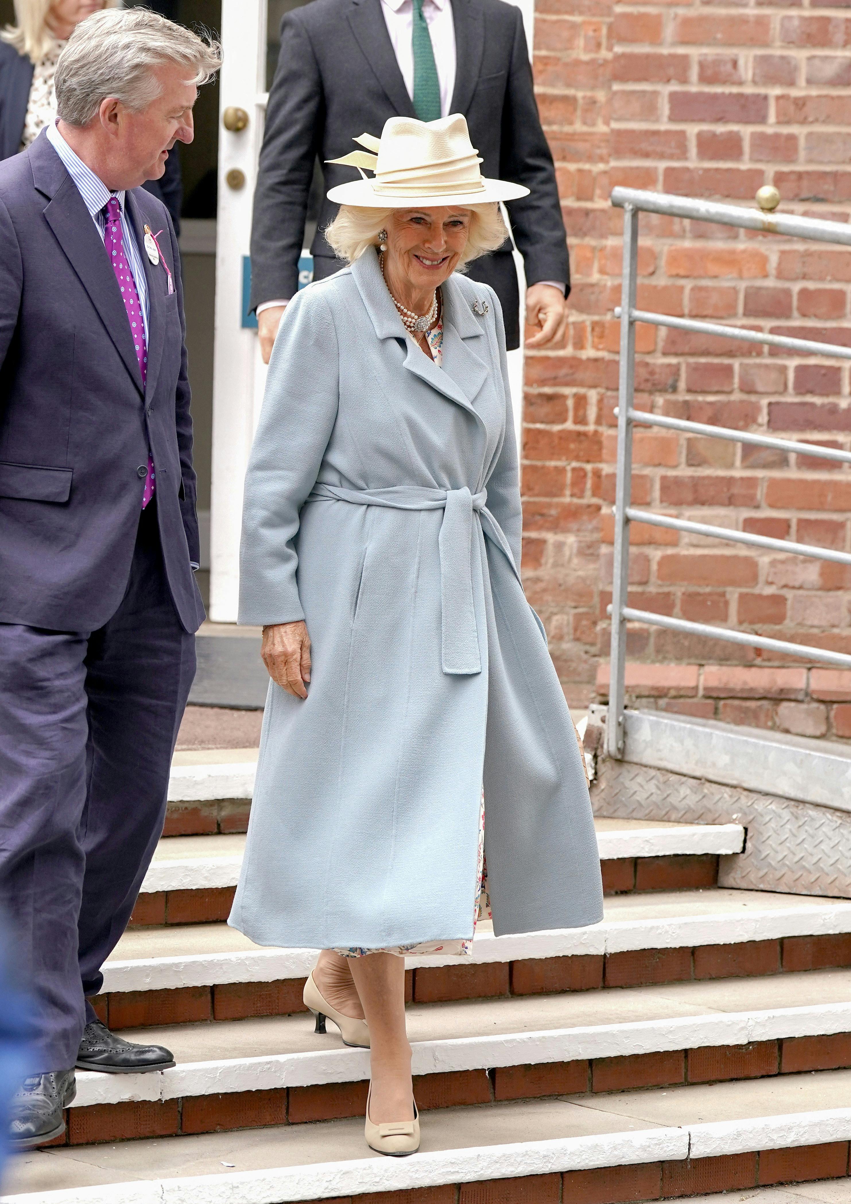 Britain's Queen Camilla smiles with Vice Lord Lieutenant of North Yorkshire, Chris Legard as she arrives for the Ebor Festival at York Racecourse in York, Britain, August 21, 2025.Ian Forsyth/Pool via REUTERS