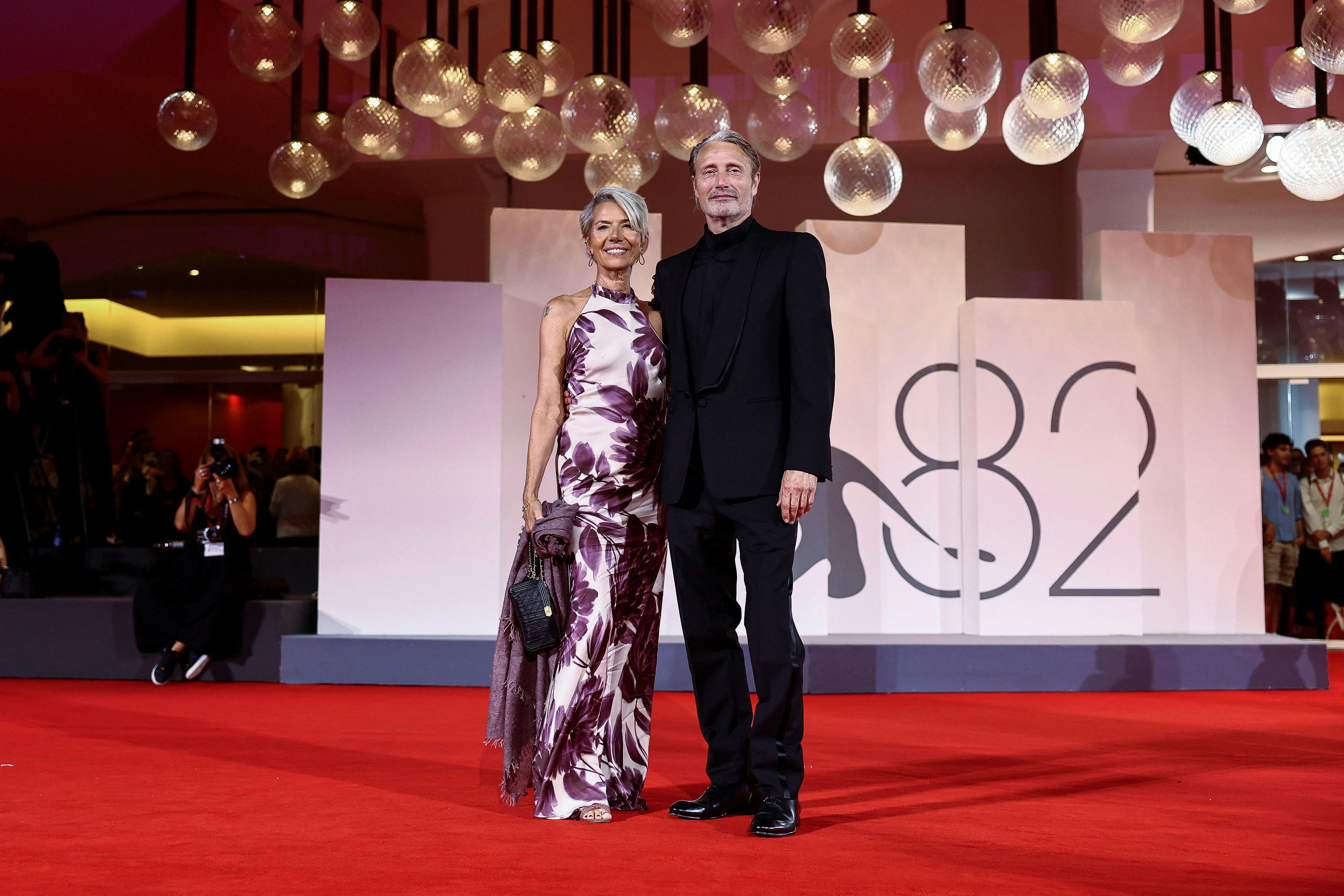 Cast member Mads Mikkelsen poses with his wife Hanne Jacobsen on the red carpet during arrivals for the screening of the movie "The Last Viking" out of competition, at the 82nd Venice International Film Festival, in Venice, Italy, August 30, 2025. REUTERS/Yara Nardi