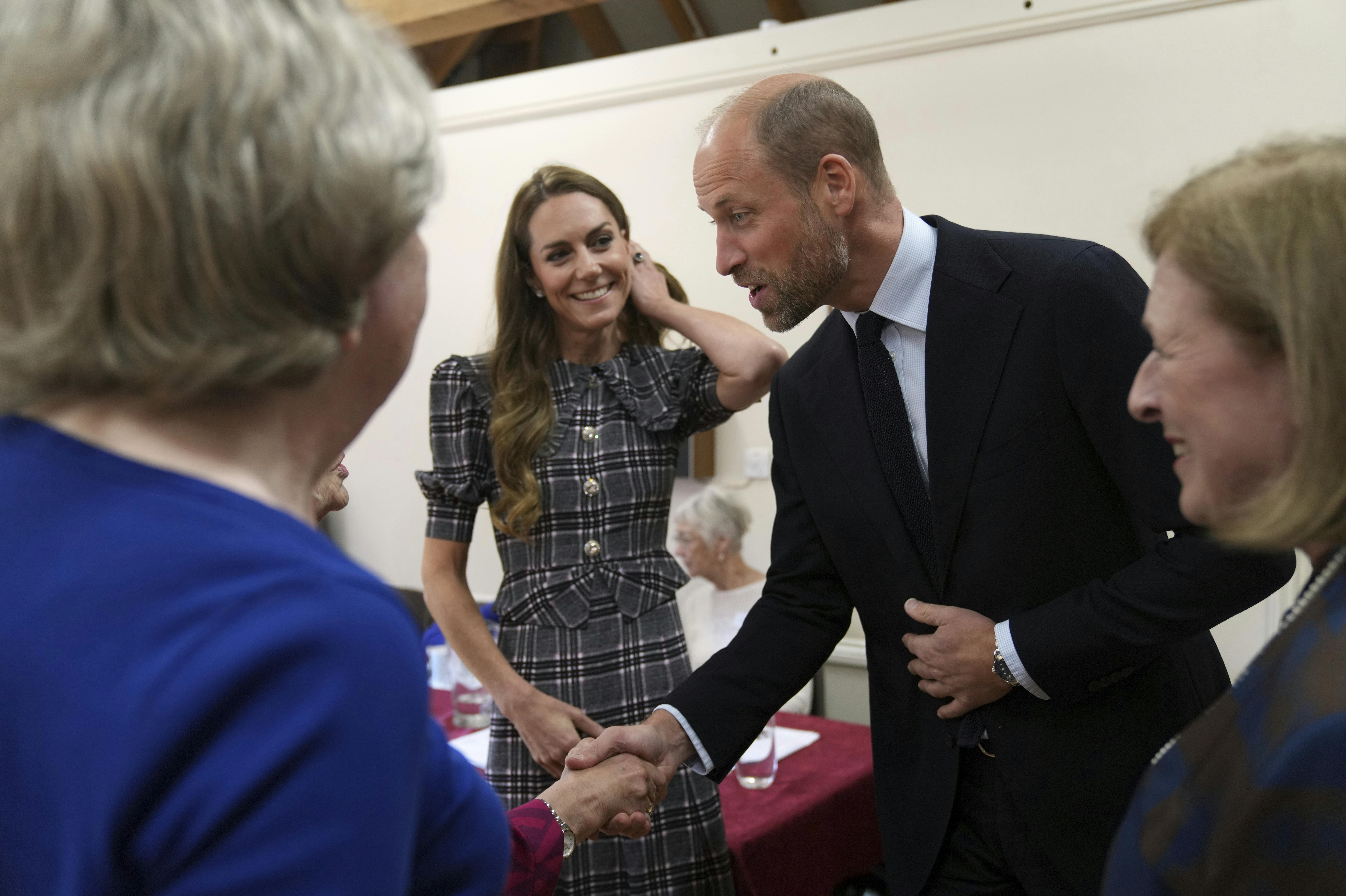 Britain's Kate and Prince William are welcomed by members as they visit the National Federation of Women's Institute (WI) to commemorate the three-year anniversary of the death of Queen Elizabeth II in Sunningdale, England, Monday, Sept. 8, 2025.(AP Photo/Alastair Grant, Pool)