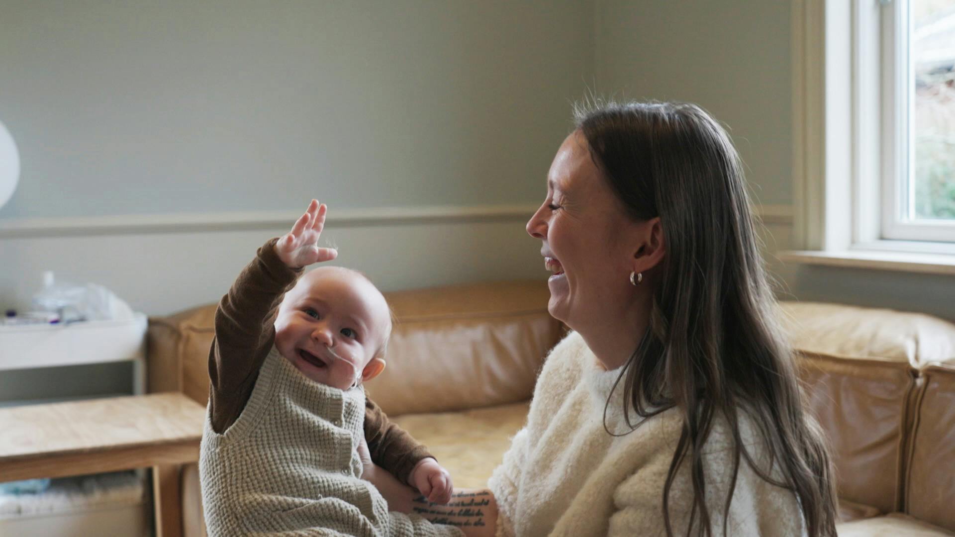 Mor Anja med lille Uma, der har lært at vinke.