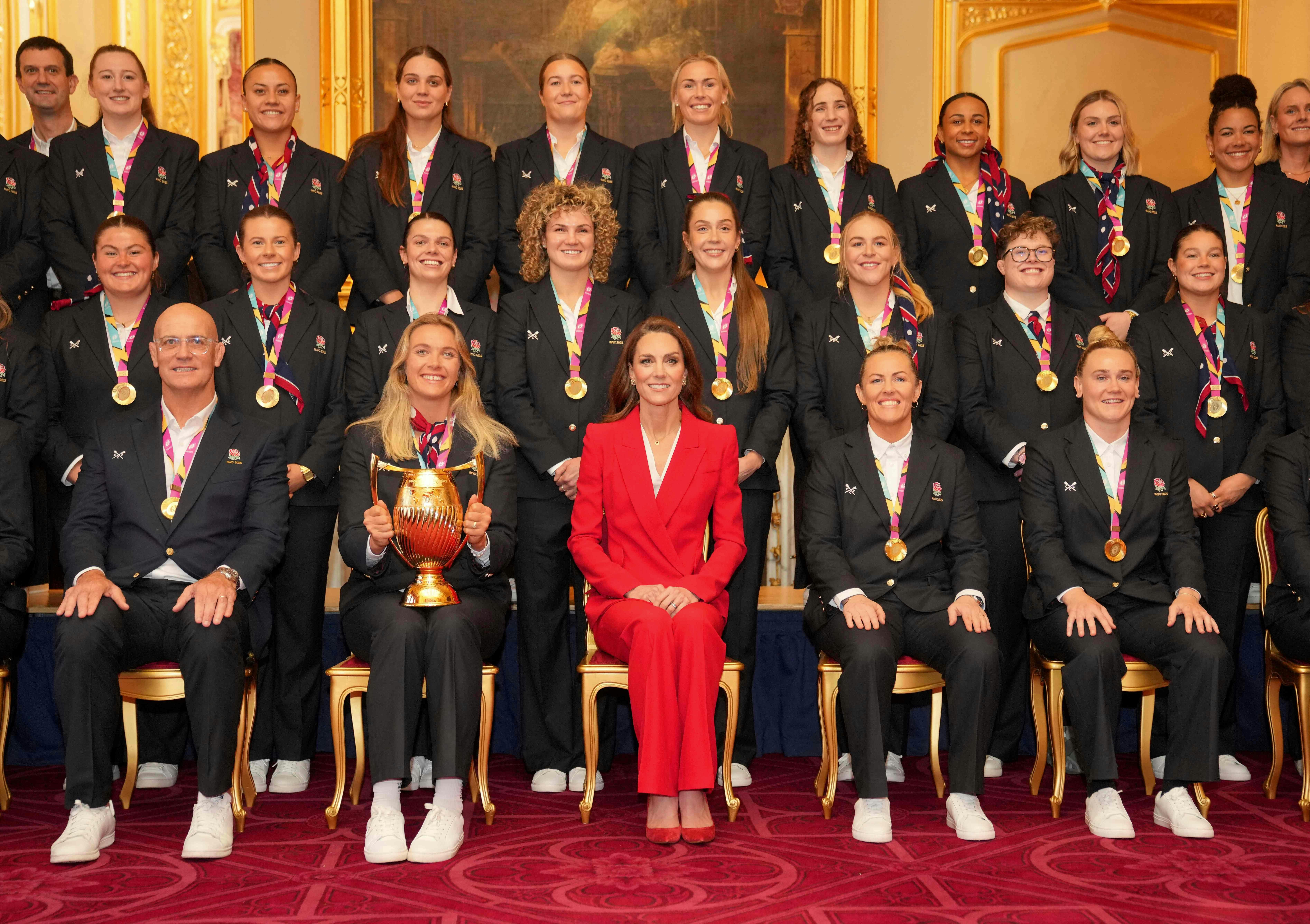 Britain's Catherine, Princess of Wales, poses with members of England Women's Rugby team during a reception following their World Cup win in 2025, at Windsor Castle in Windsor, on January 15, 2026. (Photo by Kin Cheung / POOL / AFP)