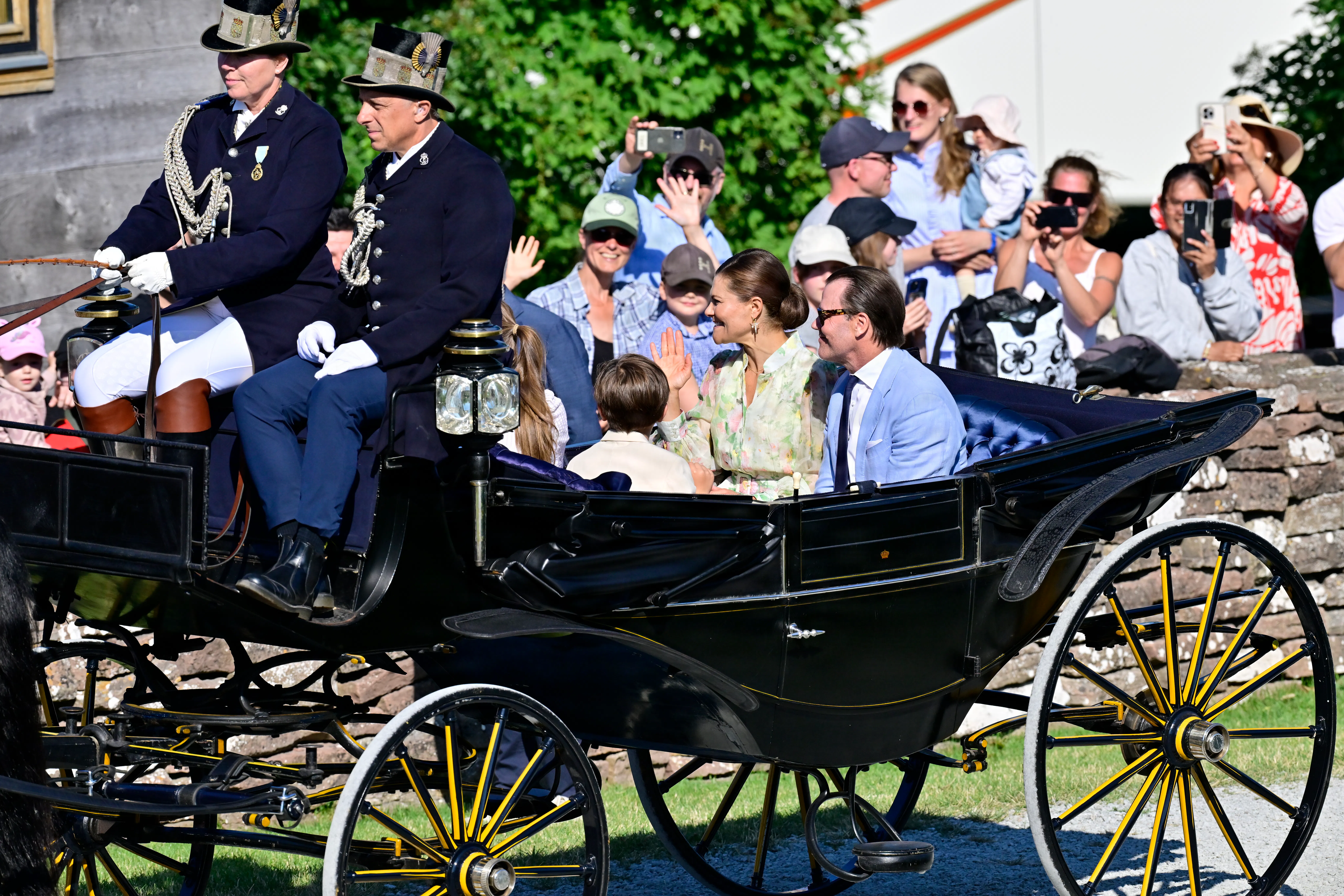 Kronprinsesse Victoria, prins Daniel, prinsesse Estelle og prins Oscar på karettur med jublende folk lang ruten.