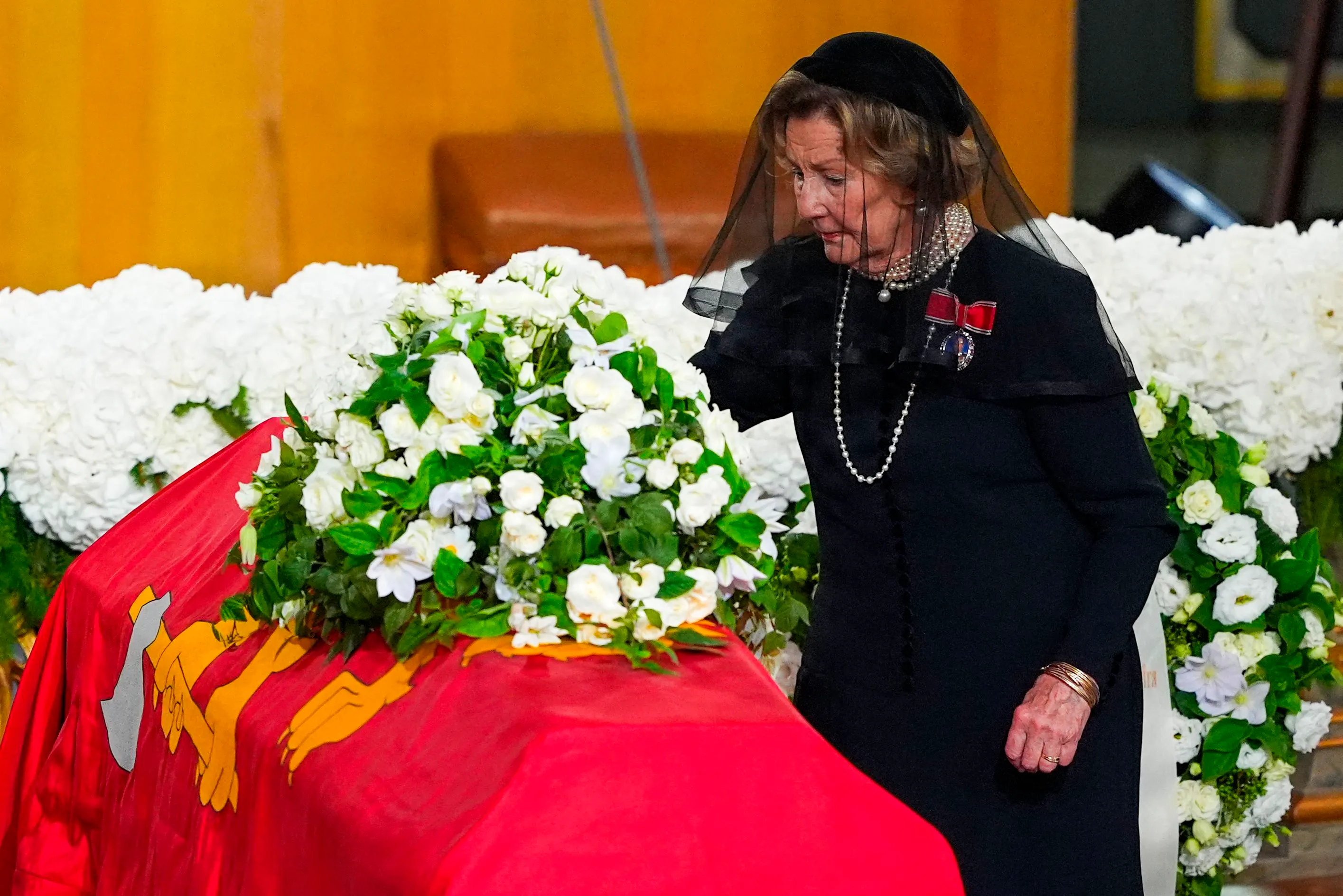 Norway's Queen Sonja places a rose on the coffin of her late husband, King Harald V, during his state funeral ceremony at Oslo Cathedral in Oslo, Norway, on September 9, 2026. King Harald V died on August 28, 2026 aged 89 and his coffin will be carried in a funeral procession from the Royal Palace along Karl Johans gate to Oslo Cathedral on September 9, 2026. (Photo by Lise Åserud / POOL / AFP)
