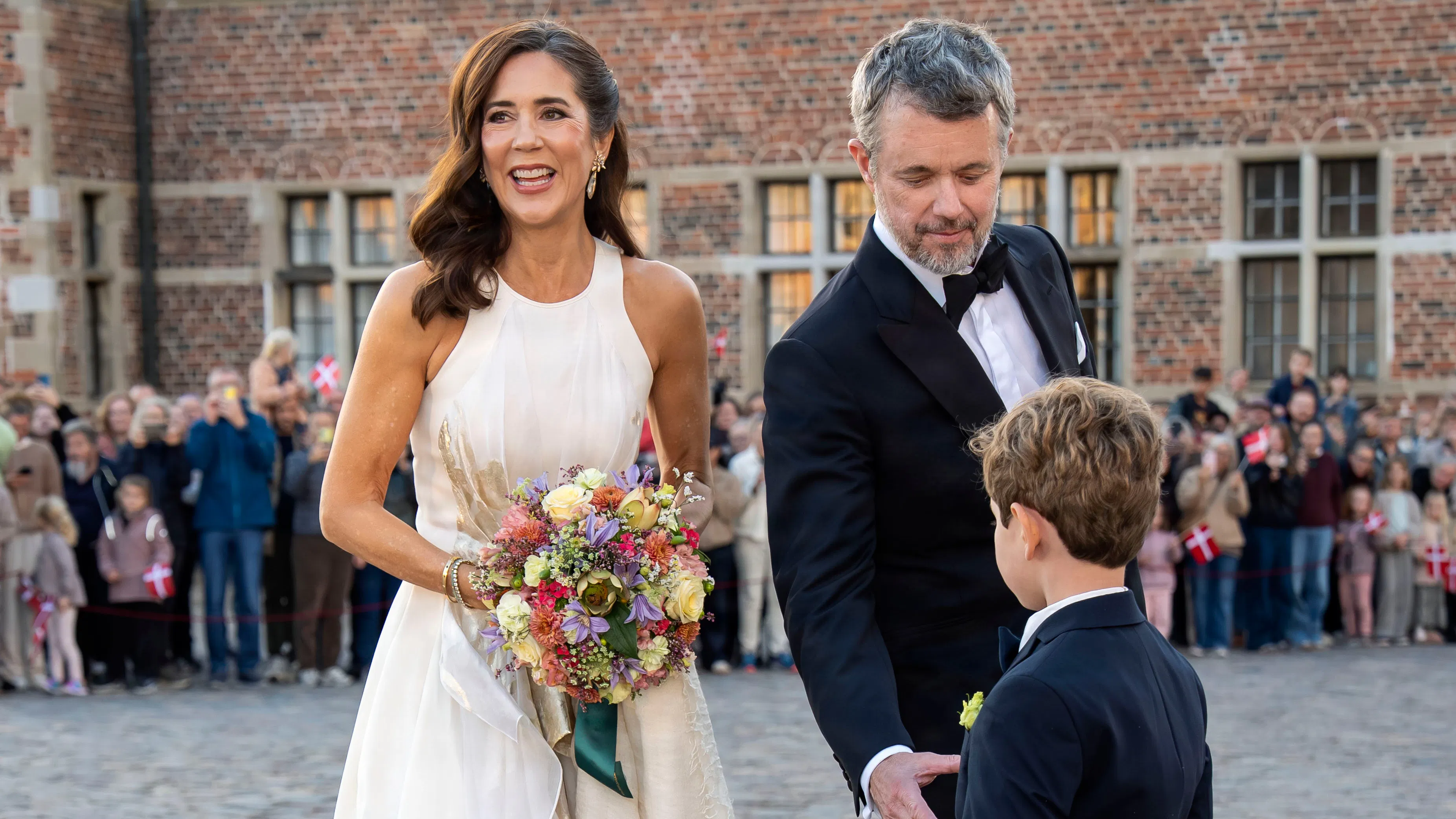 Dronning Mary og kong Frederik hilste på blomsterdrengen Alfie. 