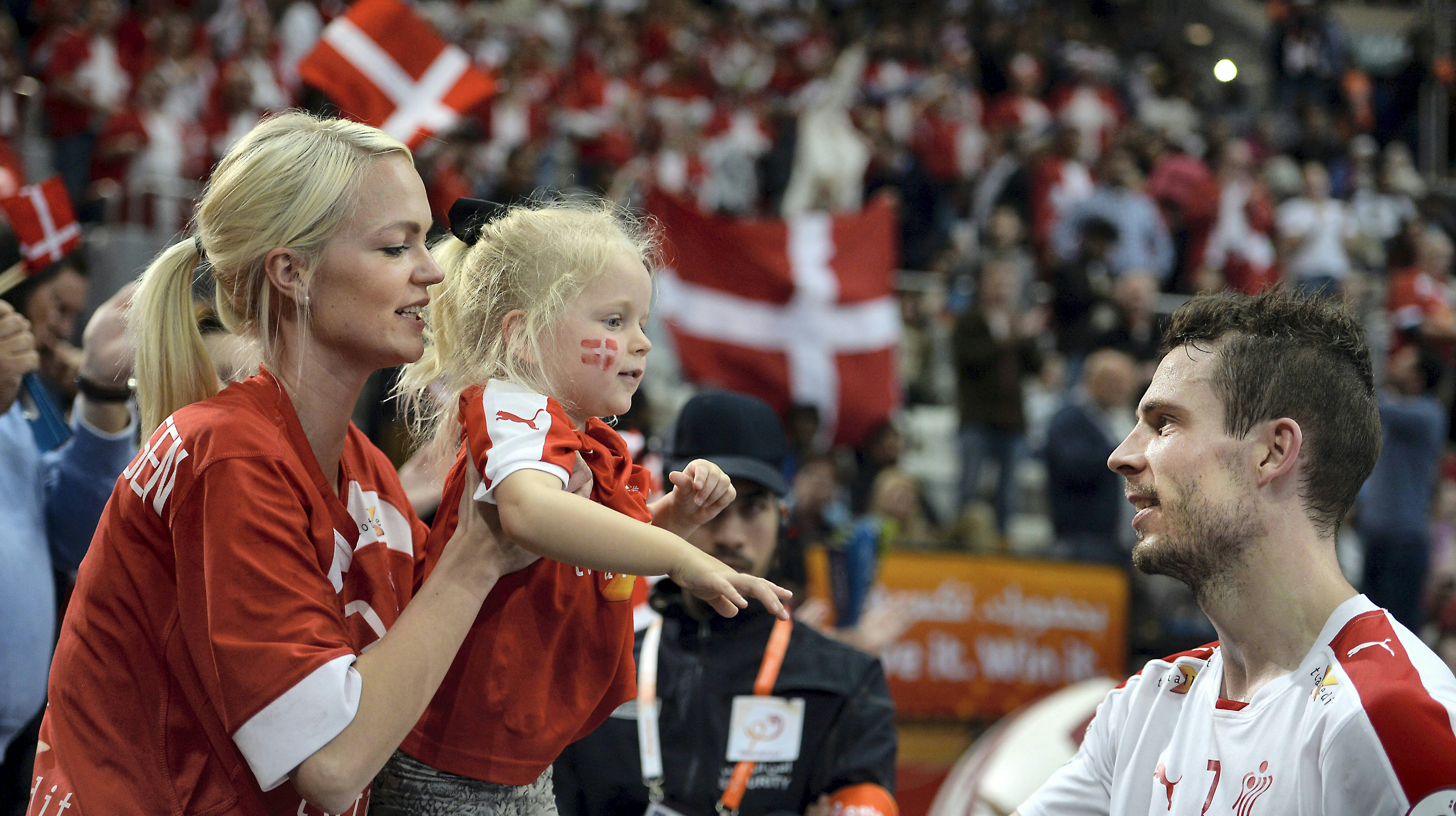 Mads Christiansen lykønskes af sin forlovede, Regitze, og parrets lille datter efter sejren mod Rusland.