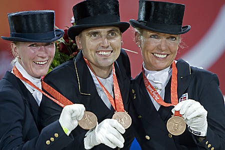 Glæden er naturligvis stor hos det danske dressurhold der her poserer stolte med deres OL-bronze medaljer. Fra venstre prinsesse Nathalie, Andreas Helgstrand og Anne van Olst.